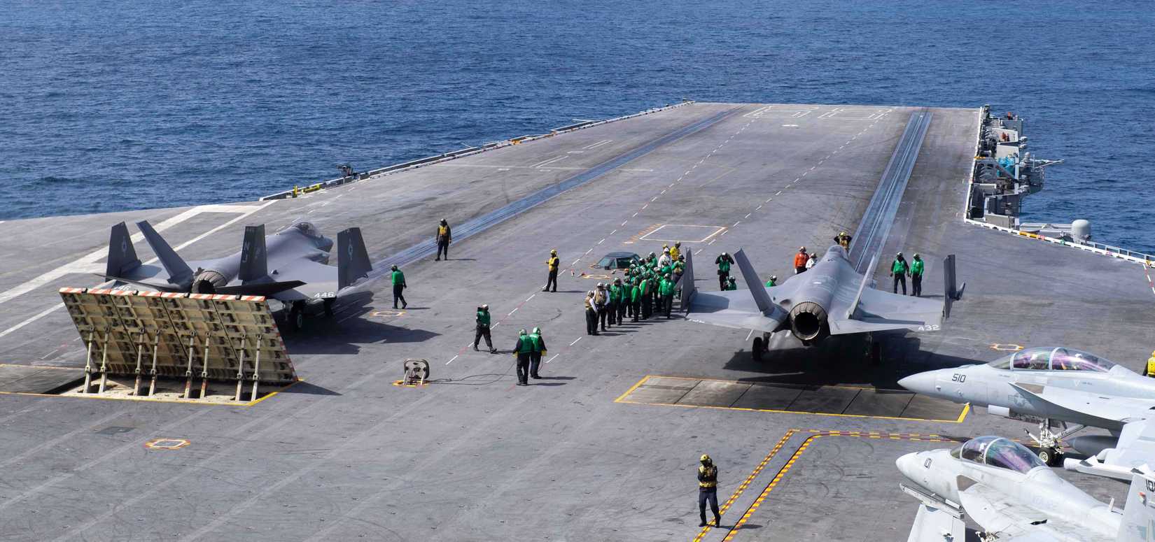 Two F-35C Lightning II's prepare to launch.