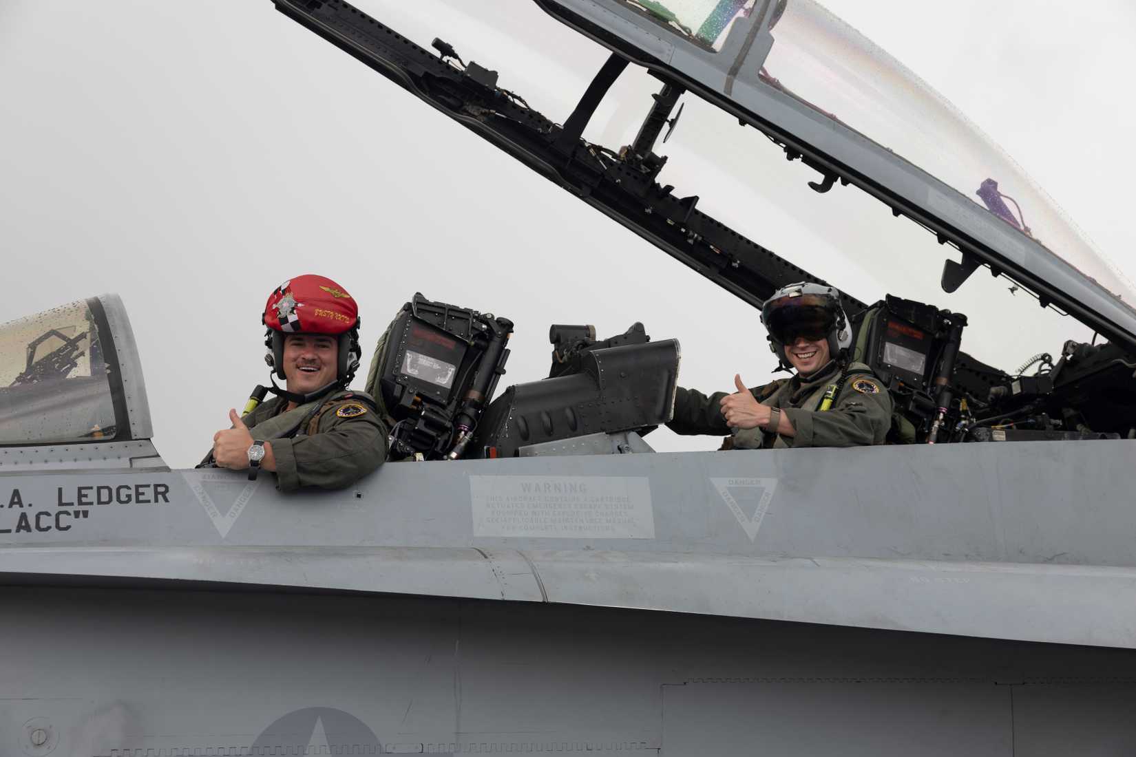 U.S. Marine Corps Capt. Tanner Morse, left, and Maj. Brady Maier, right, both FA-18 Hornet pilots with Marine Fighter Attack Squadron (VMFA) 312, prepare for flight