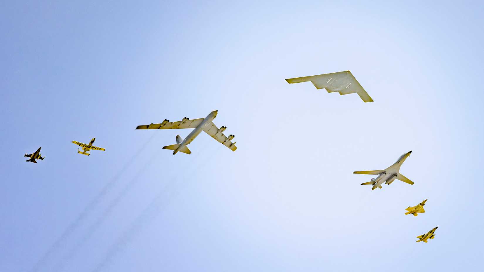 A B-2 Spirit leads a formation of a B-1 Lancer, B-52 Stratofortress, A-10 Warthog, F-16 Fighting Falcon, F-15 Eagle and F-22 Raptor