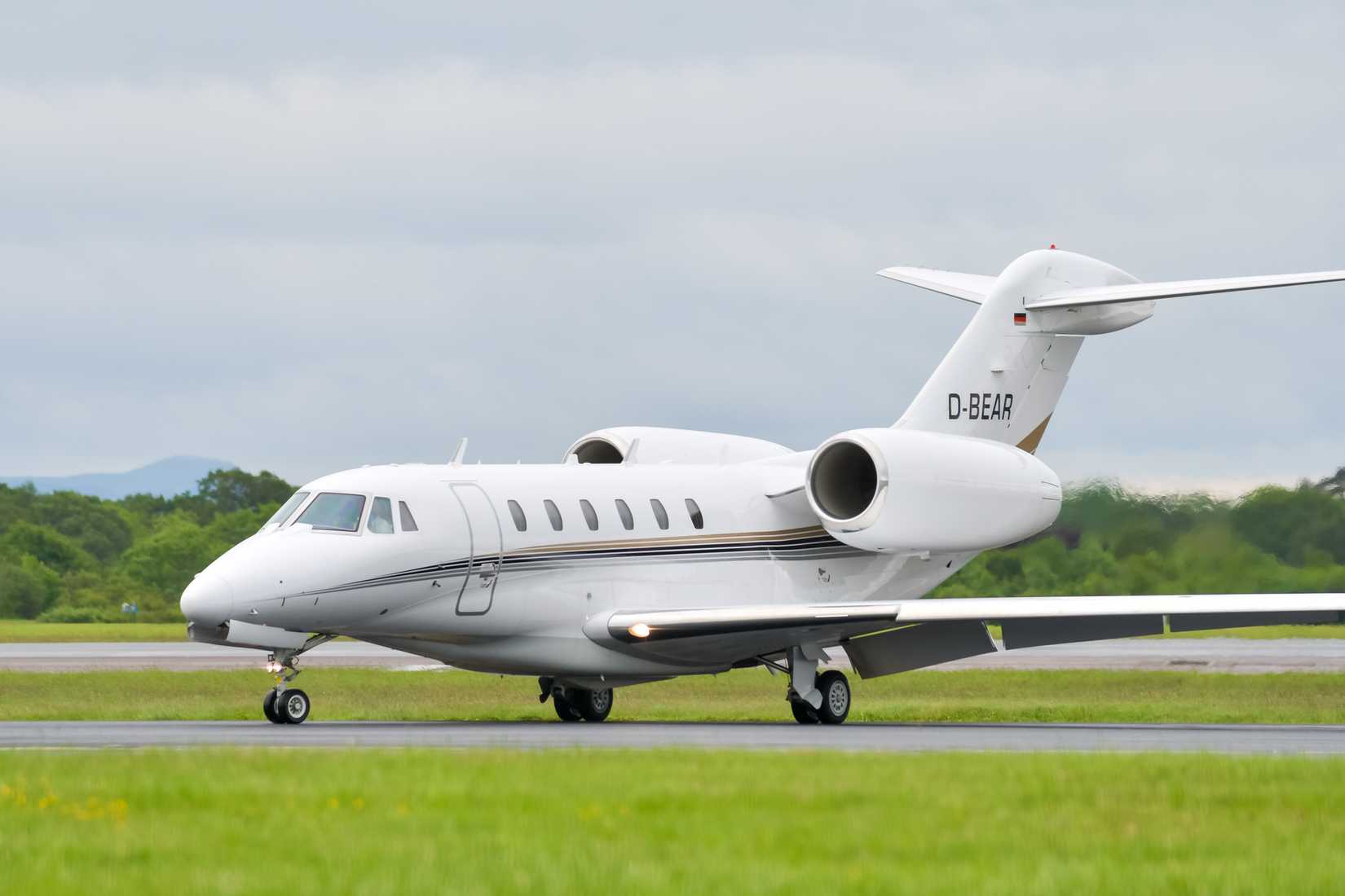 Cessna 750 Citation X executive jet turns off runway 23R at Manchester Airport after landing