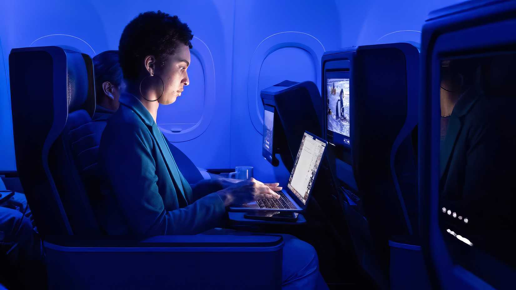 United Airlines photo of passenger in first class using laptop