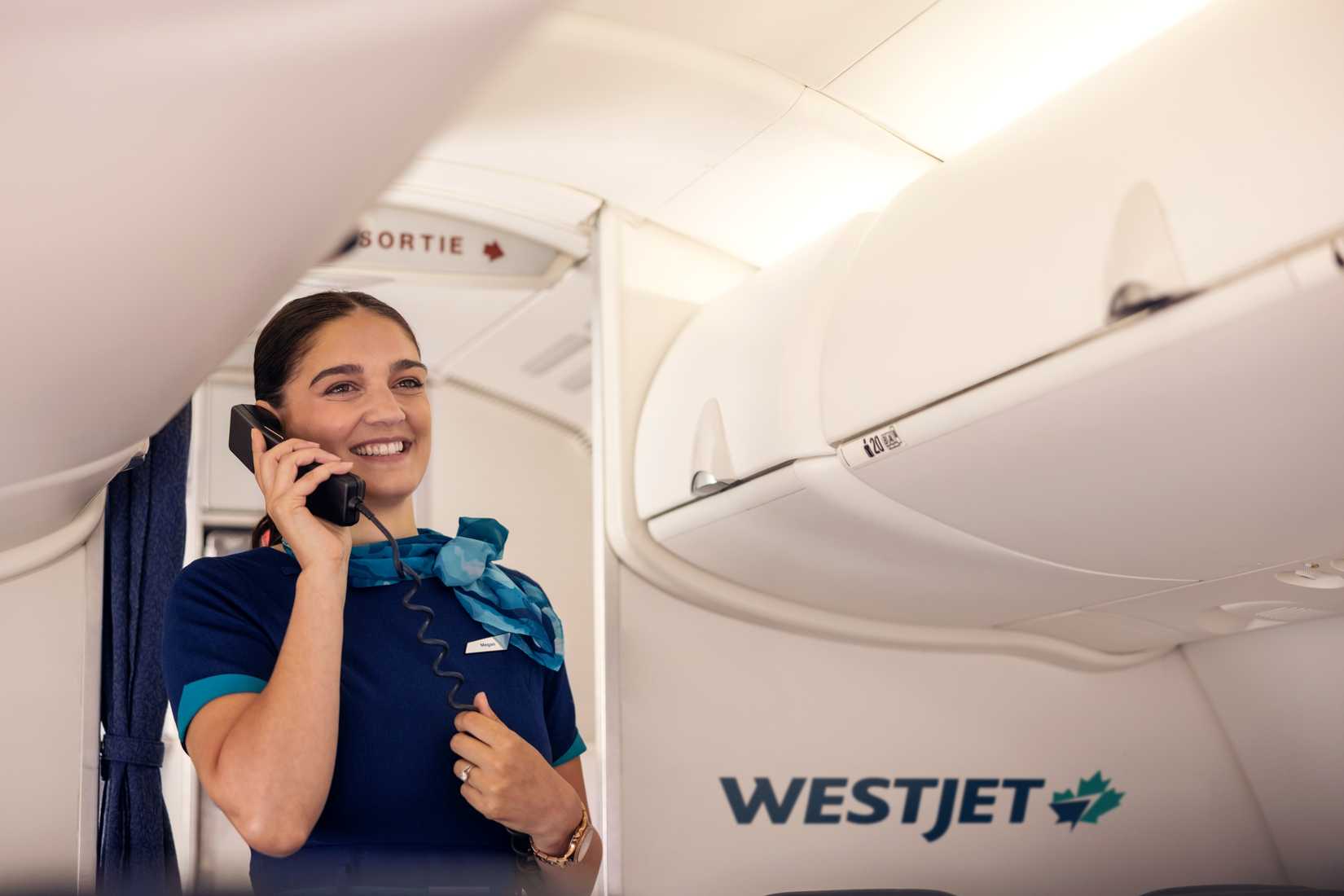 WestJet Cabin attendant makes a call