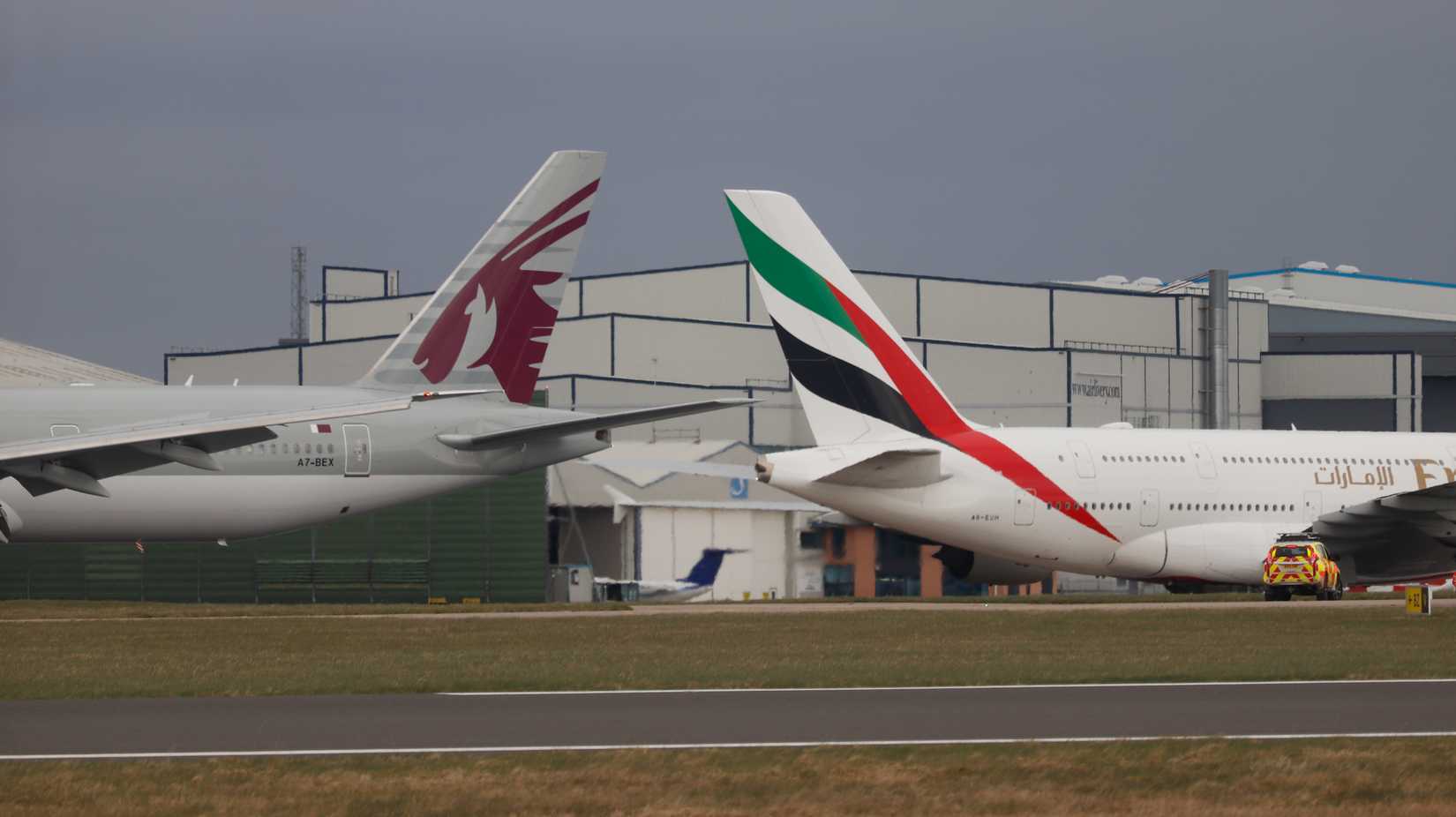 Emirates and Qatar Airways aircraft at Manchester Airport MAN shutterstock_2138709959