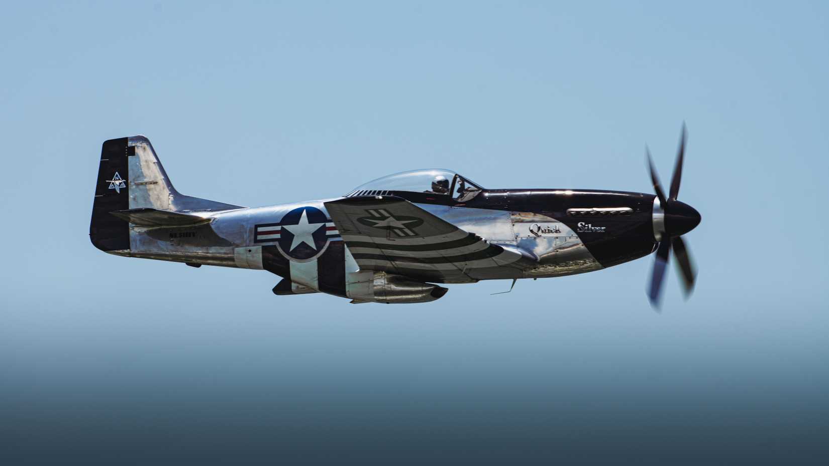 The “Quick Silver” P-51D Mustang flies over the Gulf of Mexico during the 2024 Gulf Coast Salute Air Show at Panama City Beach, Florida