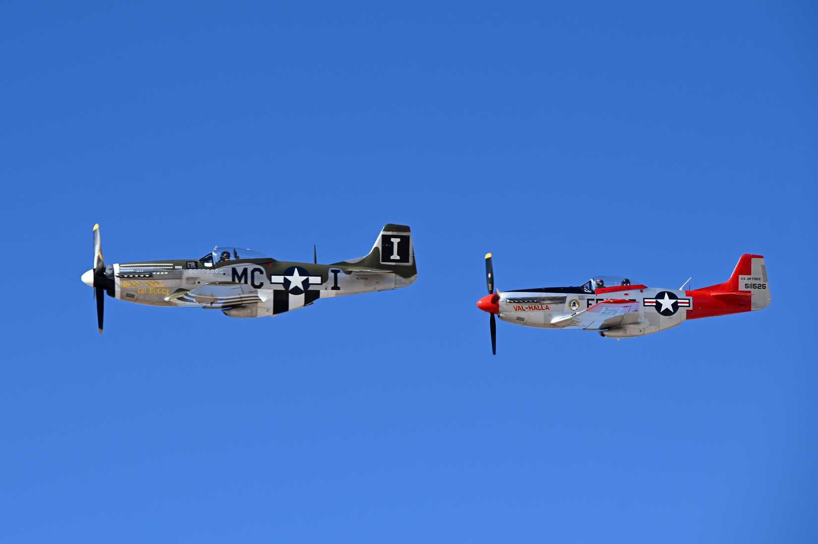 Two P-51 Mustang aircraft perform the second flight of the day as a two-man aerial demonstration during Heritage Flight Training