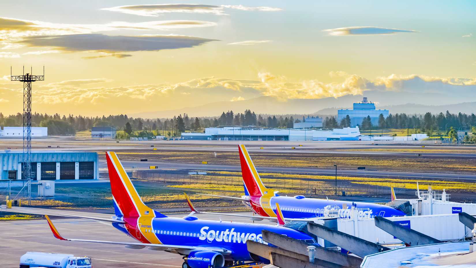 Spokane, Washington USA June 7, 2019 A pair of Southwest Airlines Boeing 737's sit parked at their airport gates just after dawn