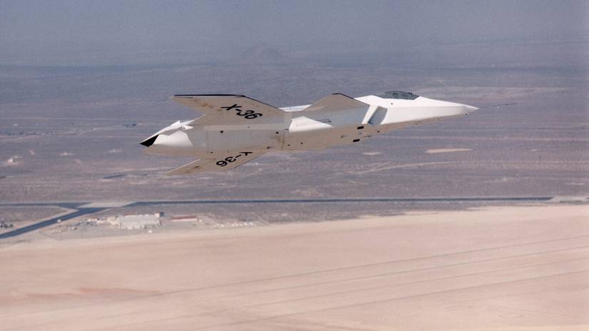 The lack of a vertical tail on the X-36 technology demonstrator is evident as the remotely piloted aircraft flies a low-altitude research flight above Rogers Dry Lake at Edwards Air Force Base