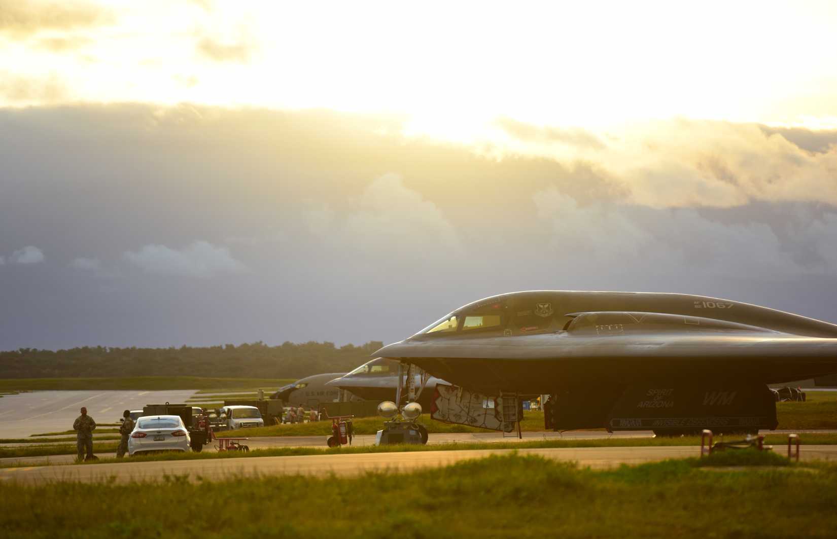 The sunset filters through the cockpit windows of two U.S. Air Force B-2 Spirits.