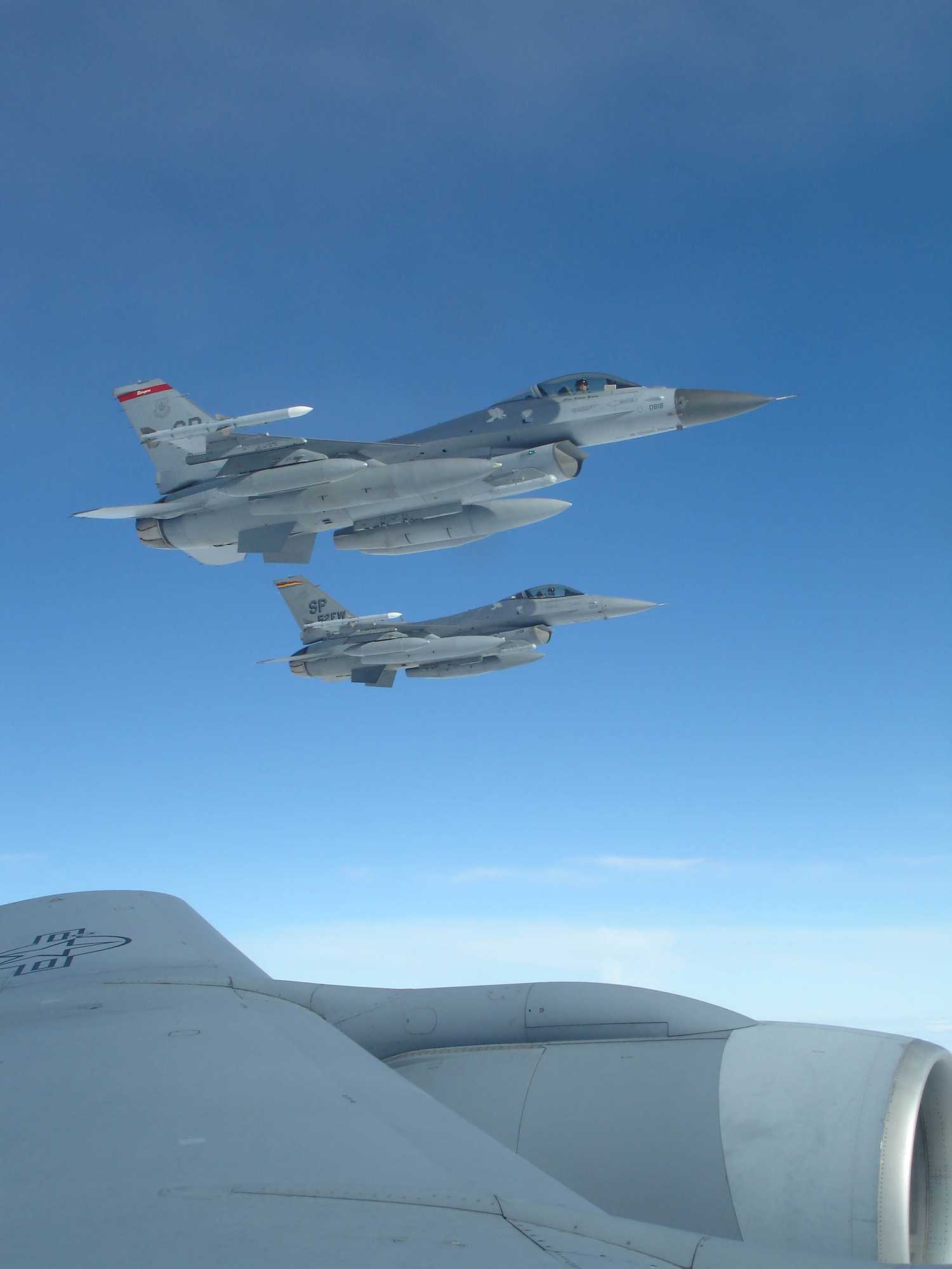 Two F-16 Fighting Falcons from Spangdahlem Air Base, Germany, await refueling from a KC-135 Stratotanker