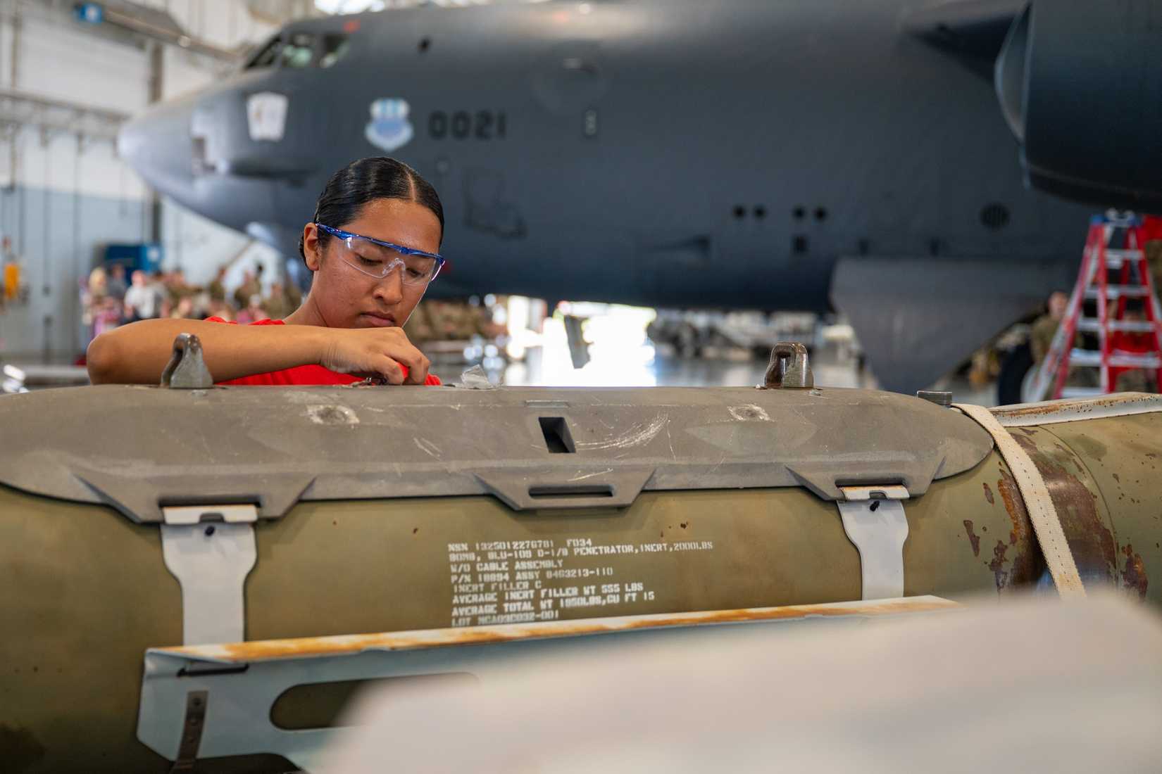U.S. Air Force Airman 1st Class Isabella Tejeda-Romero, 96th Bomber Generation Squadron weapons load crew member, prepares B-52 munitions for loading.