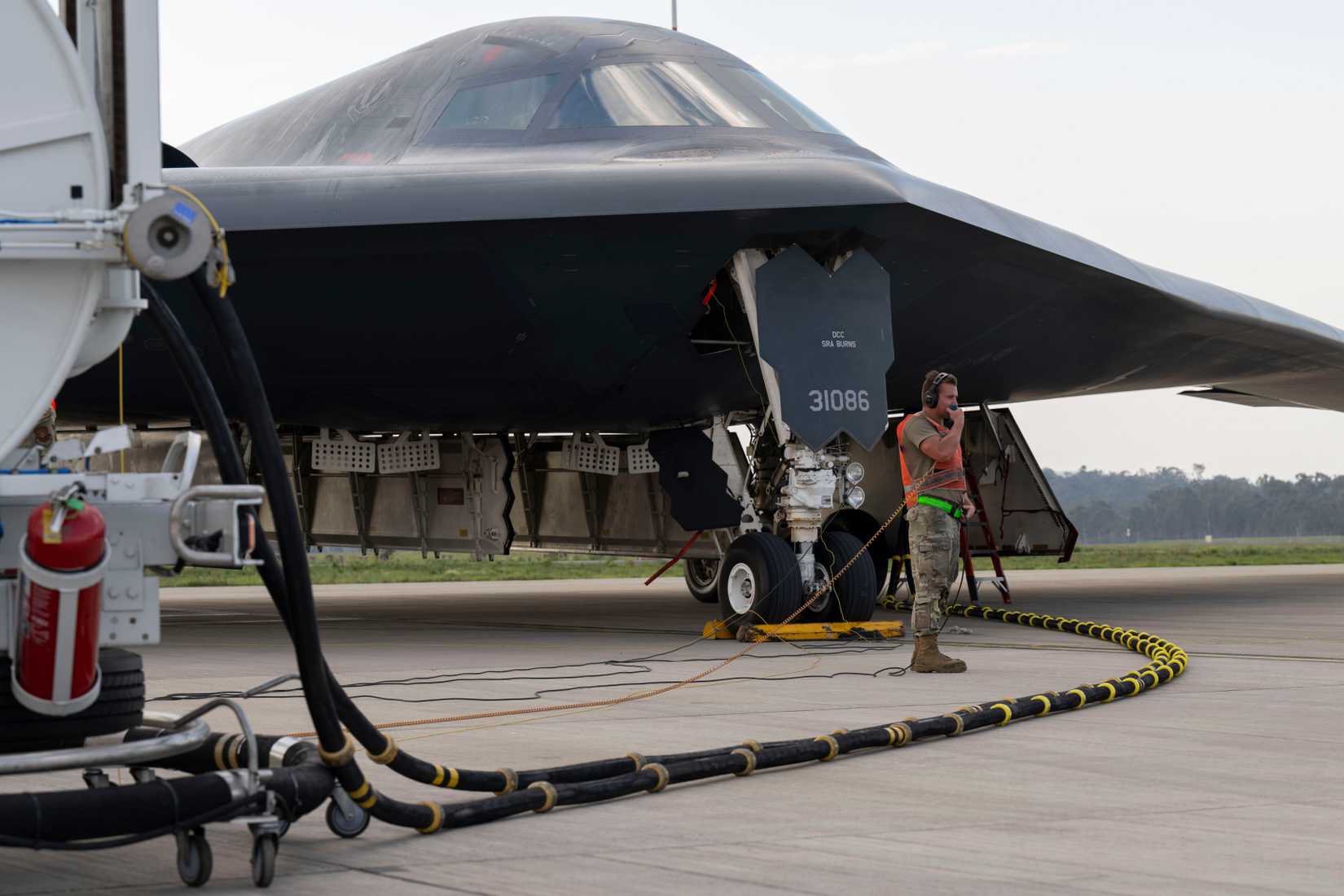 U.S. Air Force Staff Sgt. Mason Hunt,110th Expeditionary Bomb Squadron crew chief, conducts hot pit operations with a U.S. Air Force B-2 Spirit
