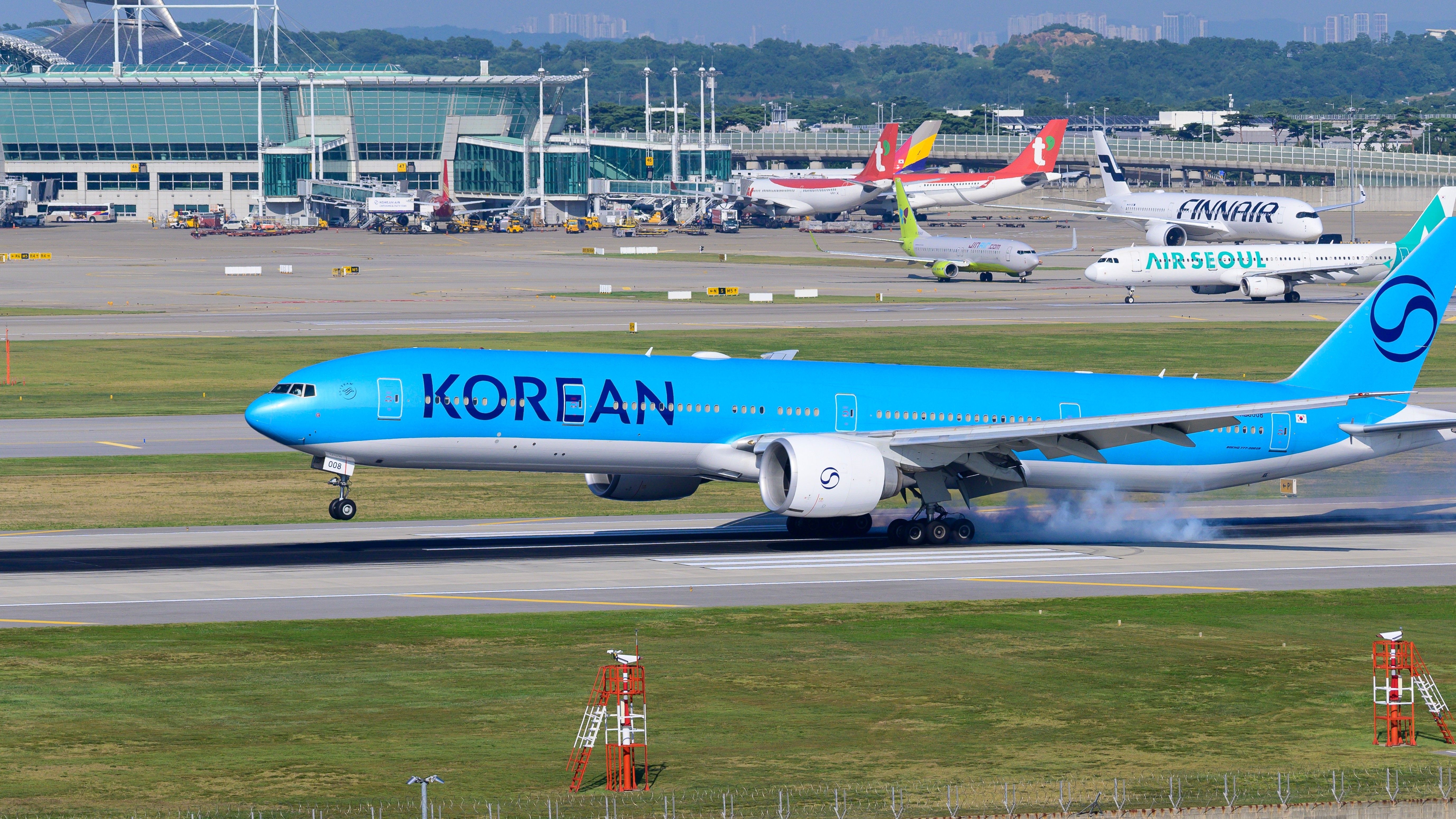 A Korean Air passenger plane landing at Incheon Airport. Korean Air new livery aircraft.