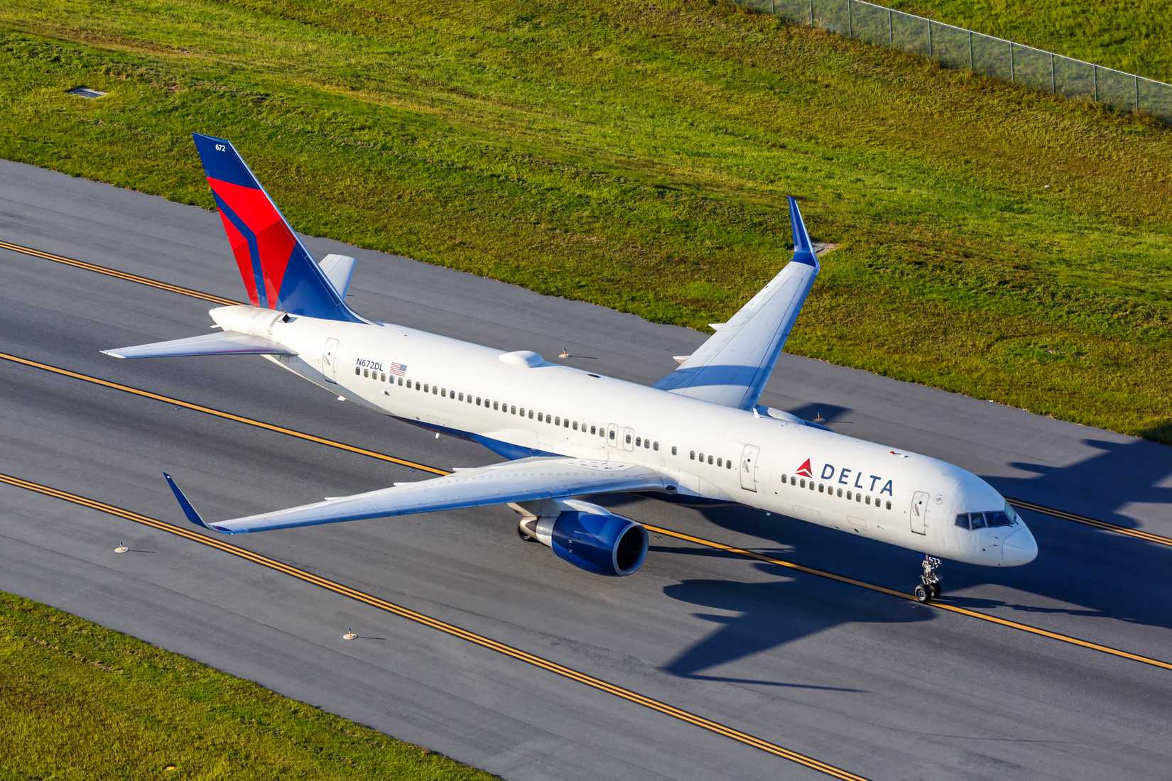 Aerial view photo of Delta Air Lines Boeing 757-200 airplane at Orlando Airport, United States.