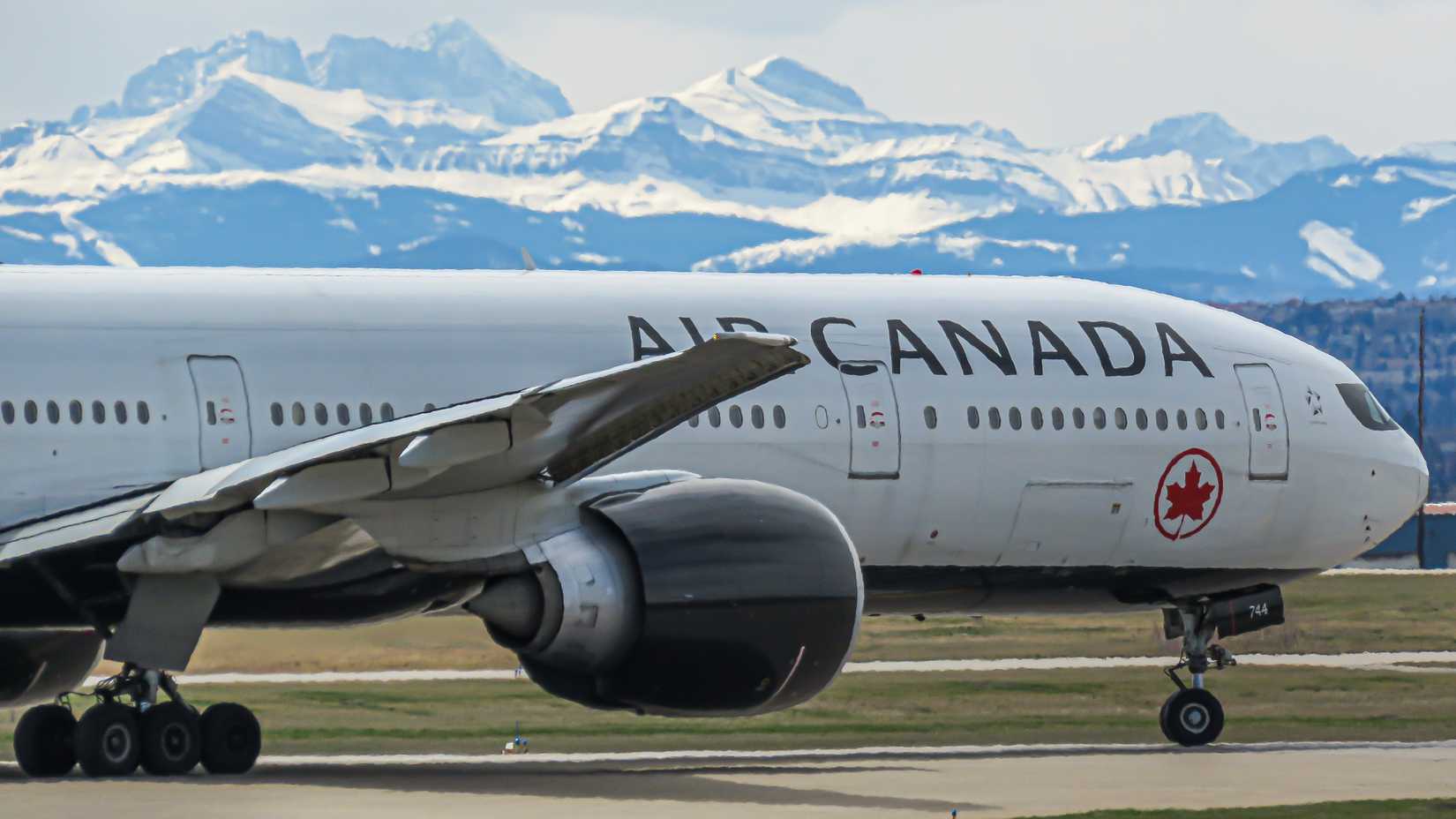 Air Canada Boeing 777 departing off Calgary’s runway 29 with the Rocky Mountains in the background.
