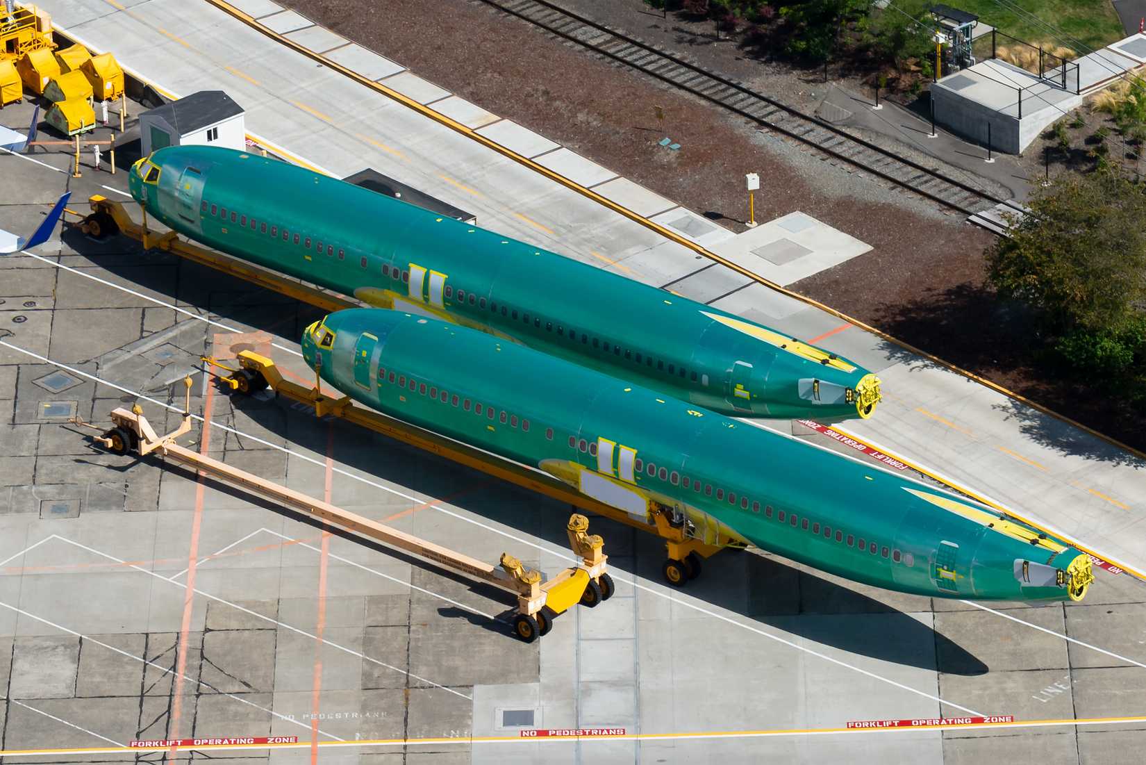 Pair of Boeing 737 (NG and MAX) fuselages wearing the protective anti corrosion green coat before entering the assembly line in Renton Airport facility