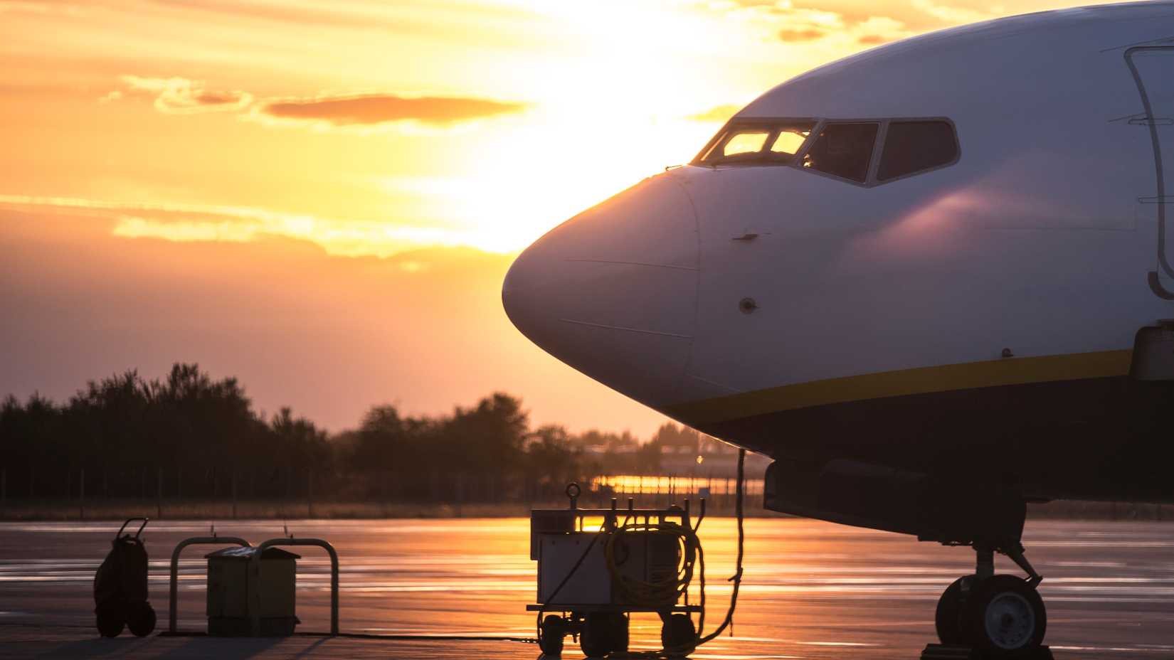 Parked 737 MAX side view backlit, sunset time. Boeing narrow body commercial jet airplane