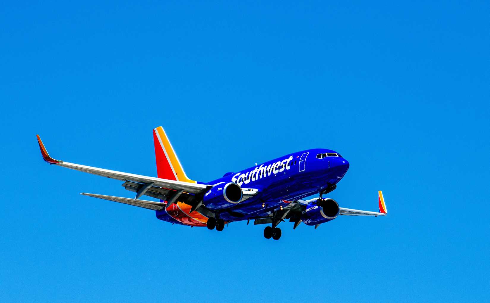 Southwest Airlines, Boeing 737-7H4, B737, narrow body aircraft landing, landing gear and flaps down. Passenger co<i></i>nnection flight commuter service