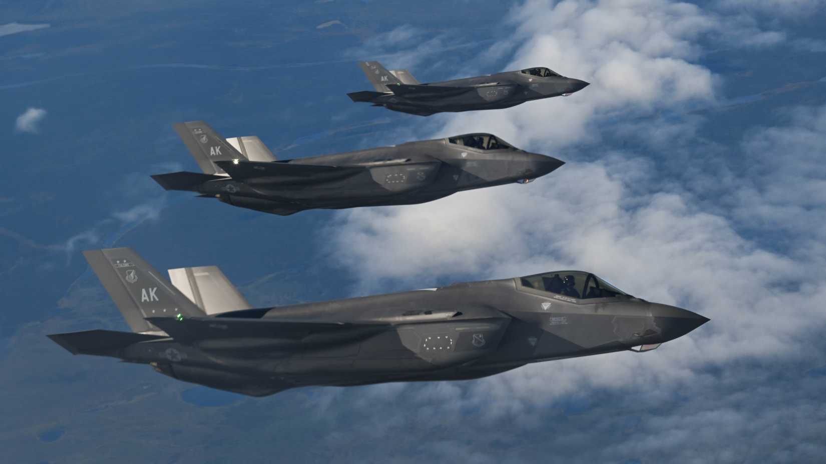 Three F-35A Lighting IIs, assigned to the 355th Fighter Squadron, prepare to receive fuel from a KC-135 Stratotanker, assigned to the 909th Air Refueling Squadron, during Northern Edge 2025.
