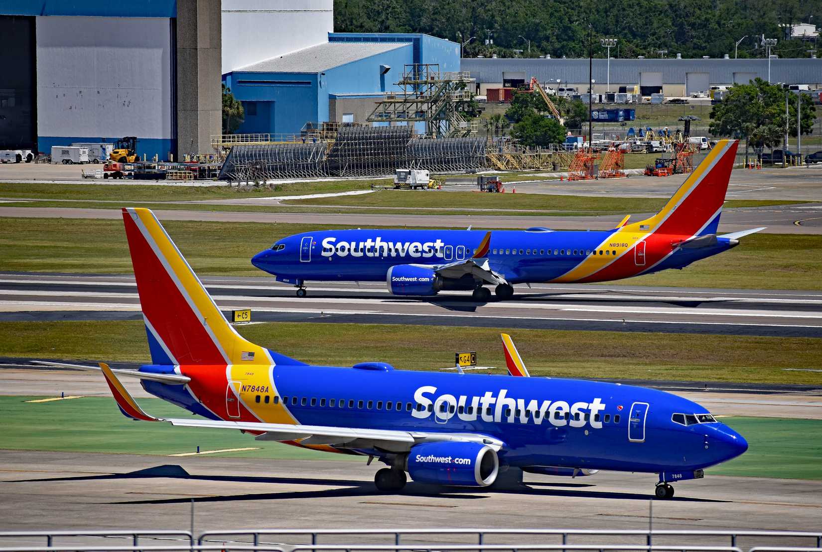 Two Southwest Airlines Boeing passenger planes, a 737 MAX 8, N8918Q departing, and a 737-700, N7848A, at Tampa International Airport,