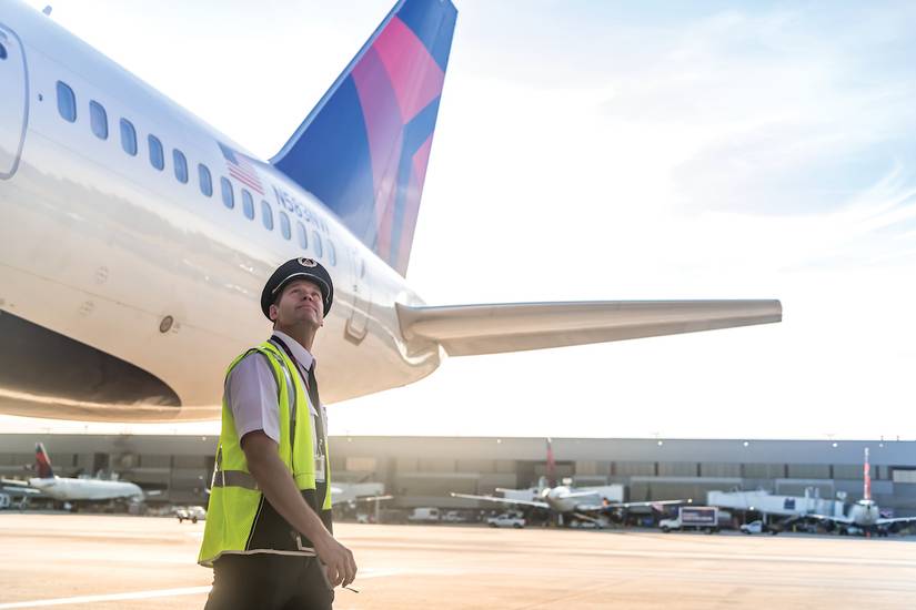 A Delta Air Lines Pilot inspects a 757.
