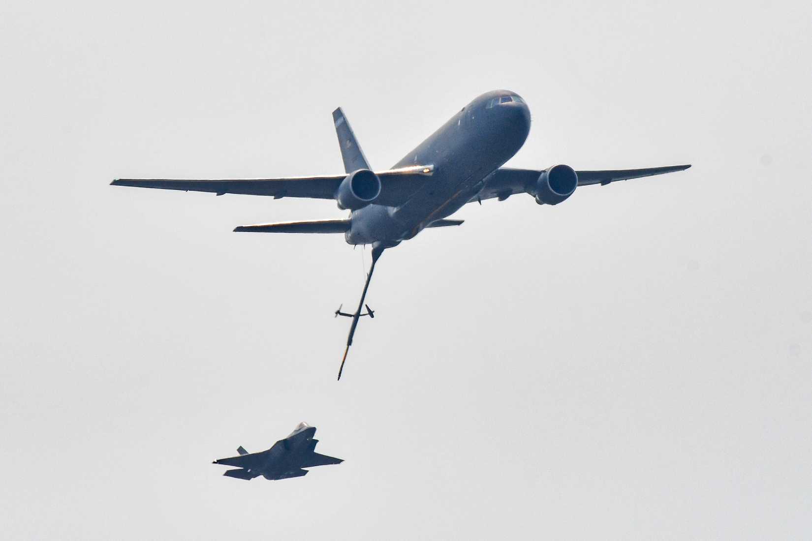 A KC-46A Pegasus assigned to the 157th Air Refueling Wing conducts a low-level pass with an F-35A Lightning II aircraft