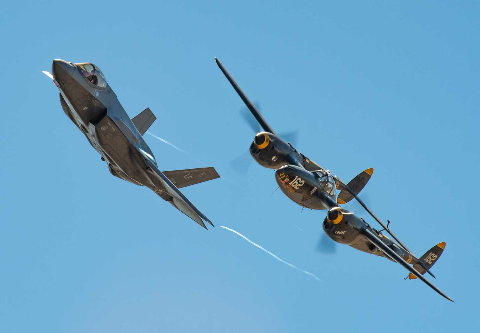 A P-38 Lightning and F-35A Lightning II fly in formation as part of a Heritage Flight display during the California Capital Airshow, Sept. 21, 2018.