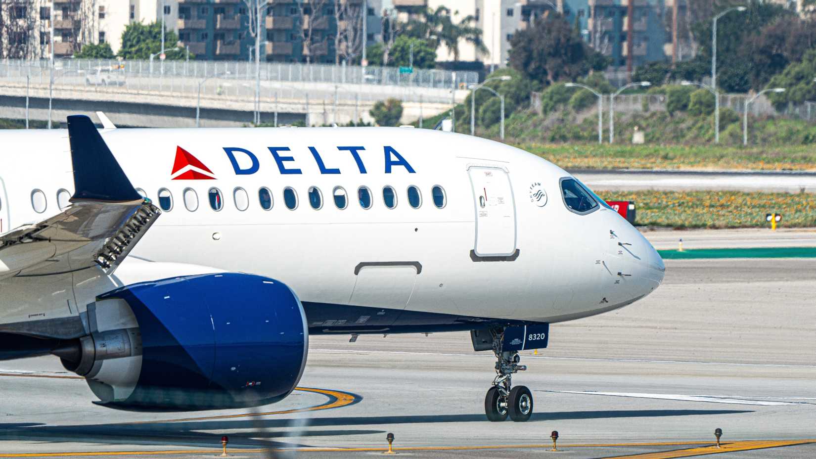 Close up of Delta Air Lines Airbus A220 taxiing on the runway at an airport