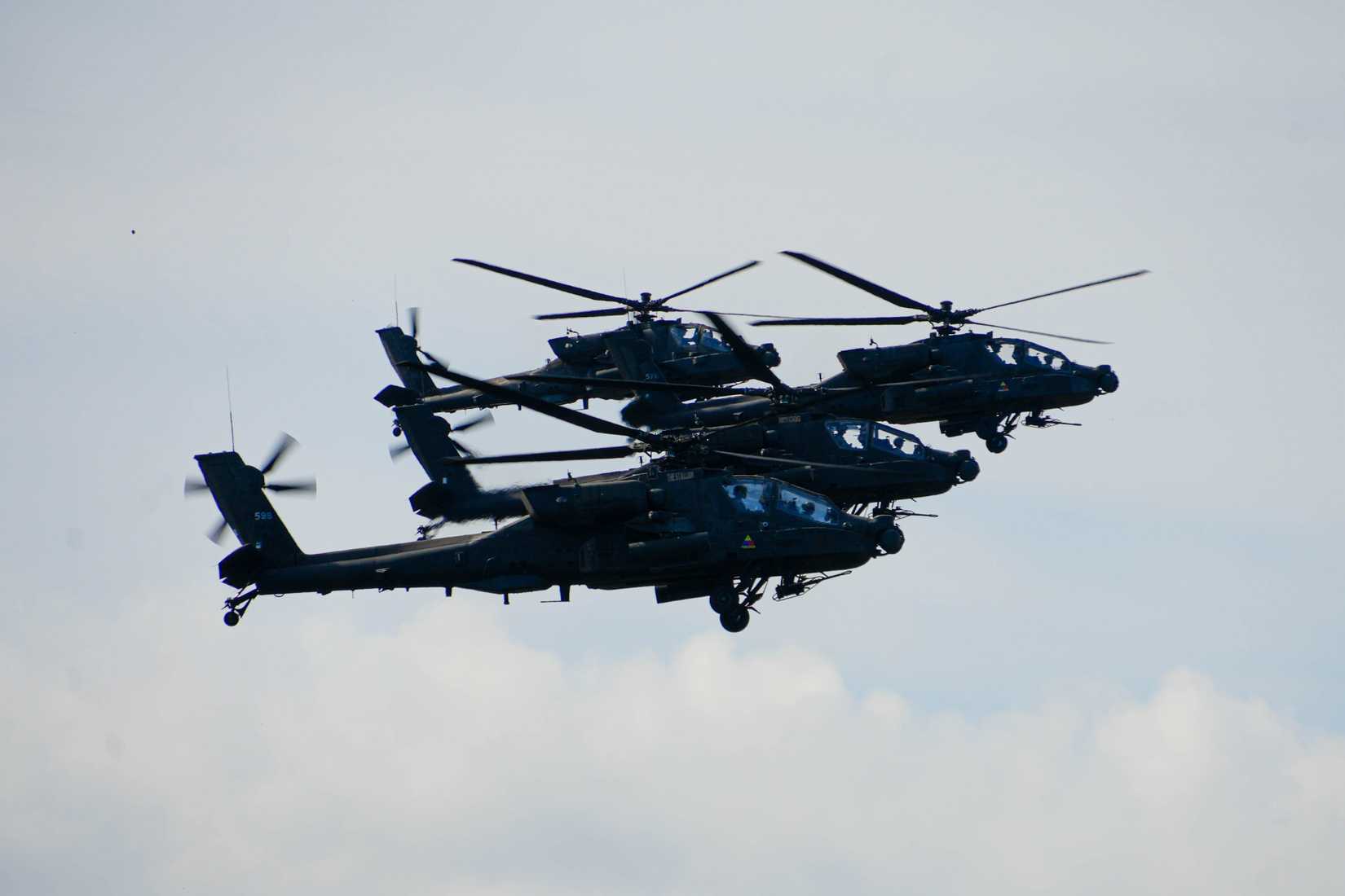 AH-64 Apaches fly above the tree line during a training mission at Camp Ādaži, Latvia, May 02, 2025.
