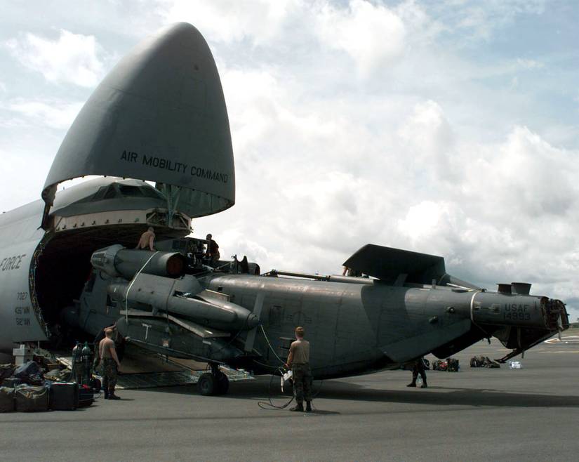 Air Force MH-53J Pave Low helicopter is unloaded from a C-5 Galaxy at the Libreville International Airport, Republic of Gabon, on March 25, 1997.