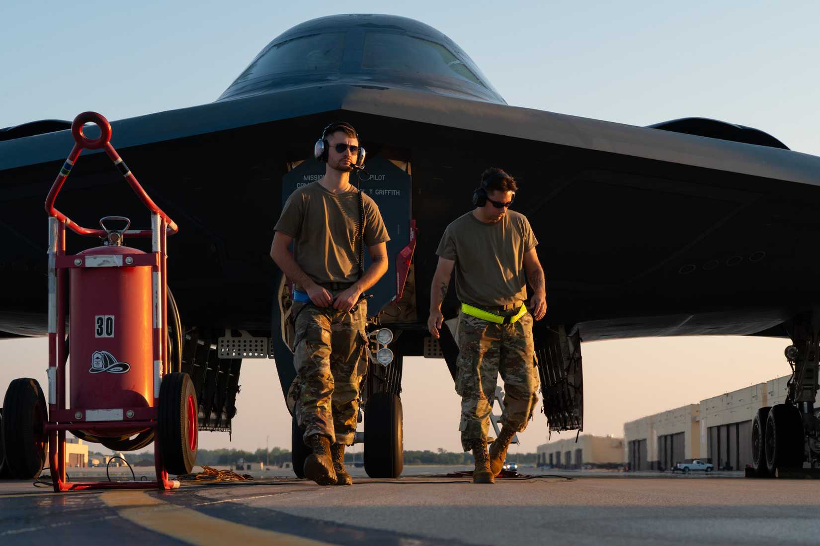 Airmen assigned to the 393rd Bomber Generation Squadron walk in front of a B-2 Spirit aircraft at Whiteman Air Force Base, Missouri, Aug. 13, 2025.