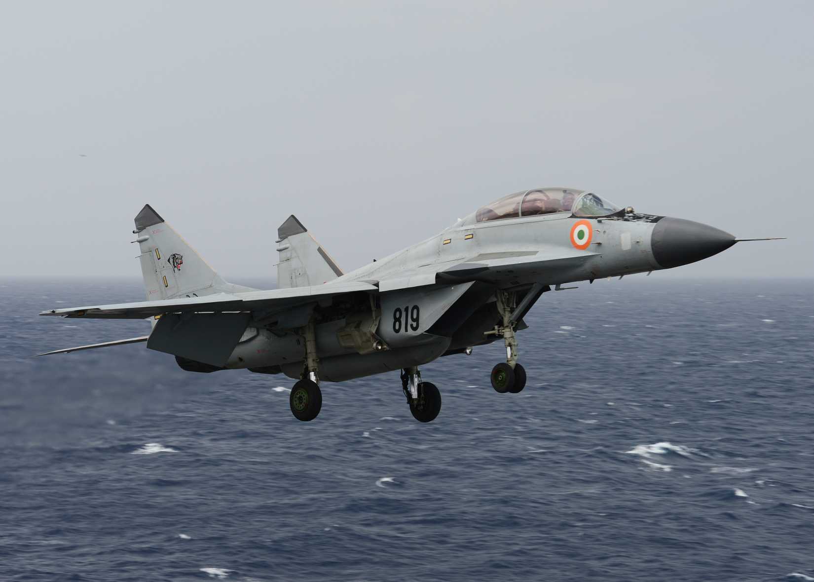 An Indian navy MIG-29K Fulcrum flies over the aircraft carrier USS Nimitz (CVN 68) during Exercise Malabar 2017.