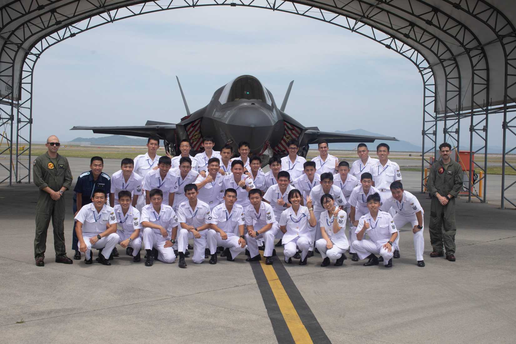 apanese Maritime Self-Defense Force cadets pose for a photo in front of a F-35B Lightning II aircraft with Marine Fighter Attack Squadron (VMFA) 211.