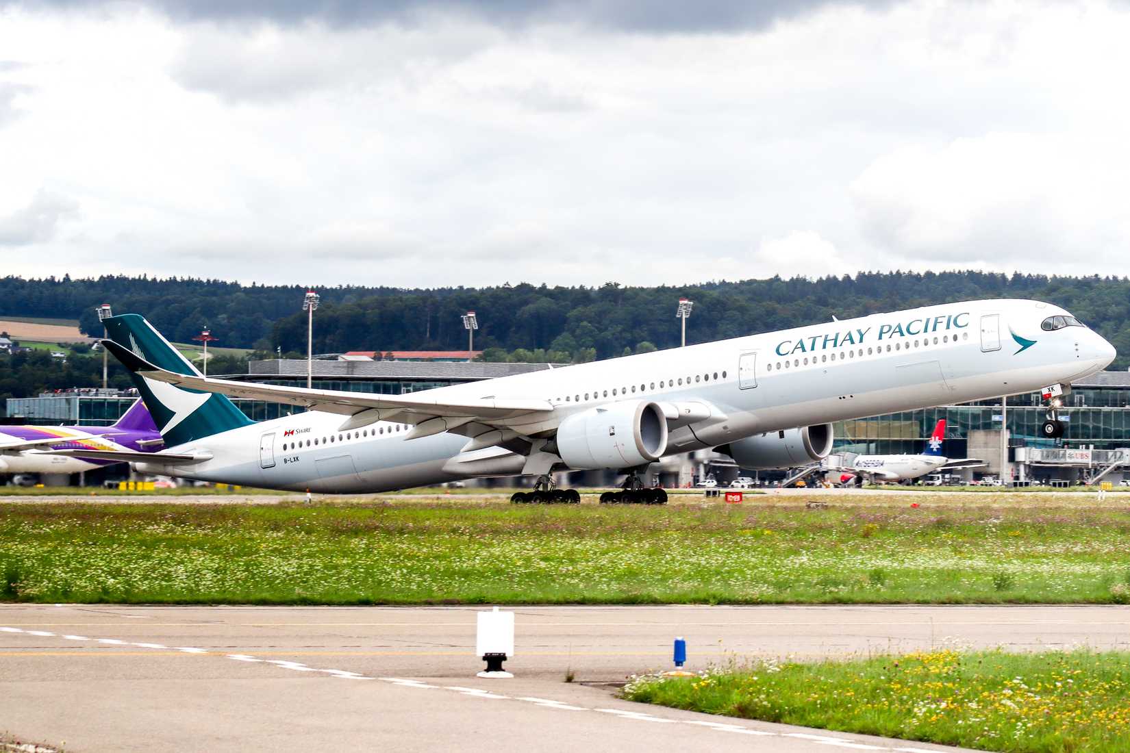 Cathay Pacific Airbus A350-1000 takeoff at Zurich Airport.