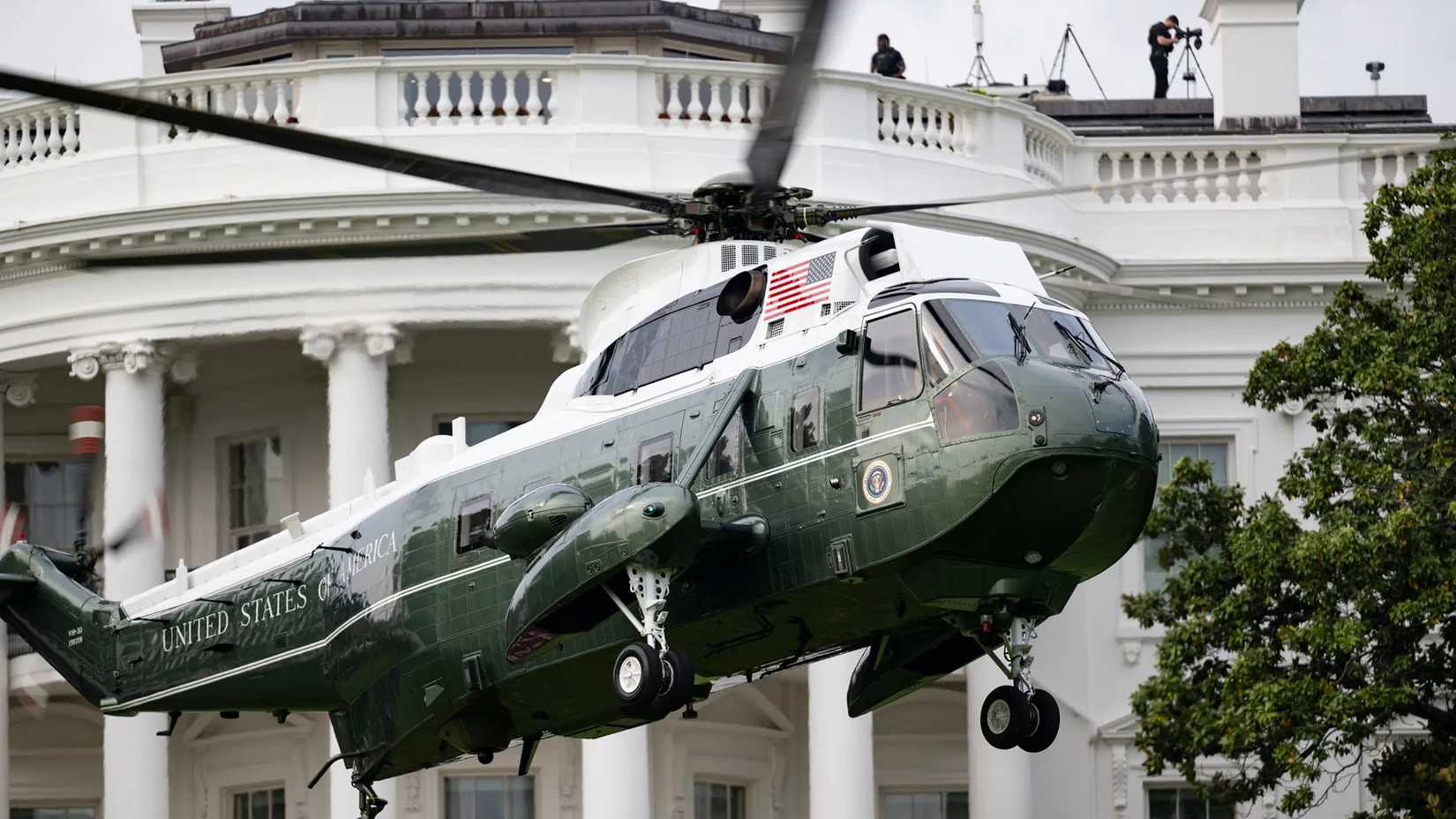 Cover, Marine One lands on the White House south lawn