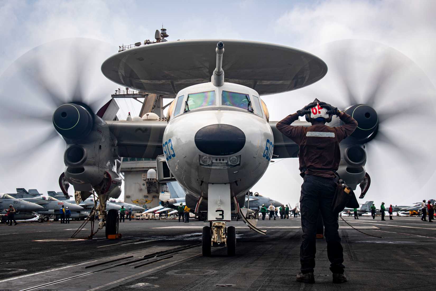 E-2D Hawkeye, attached to Carrier Airborne Early Warning Squadron (VAW) 121, during pre-flight checks aboard the Nimitz-class aircraft carrier USS Nimitz (CVN 68).