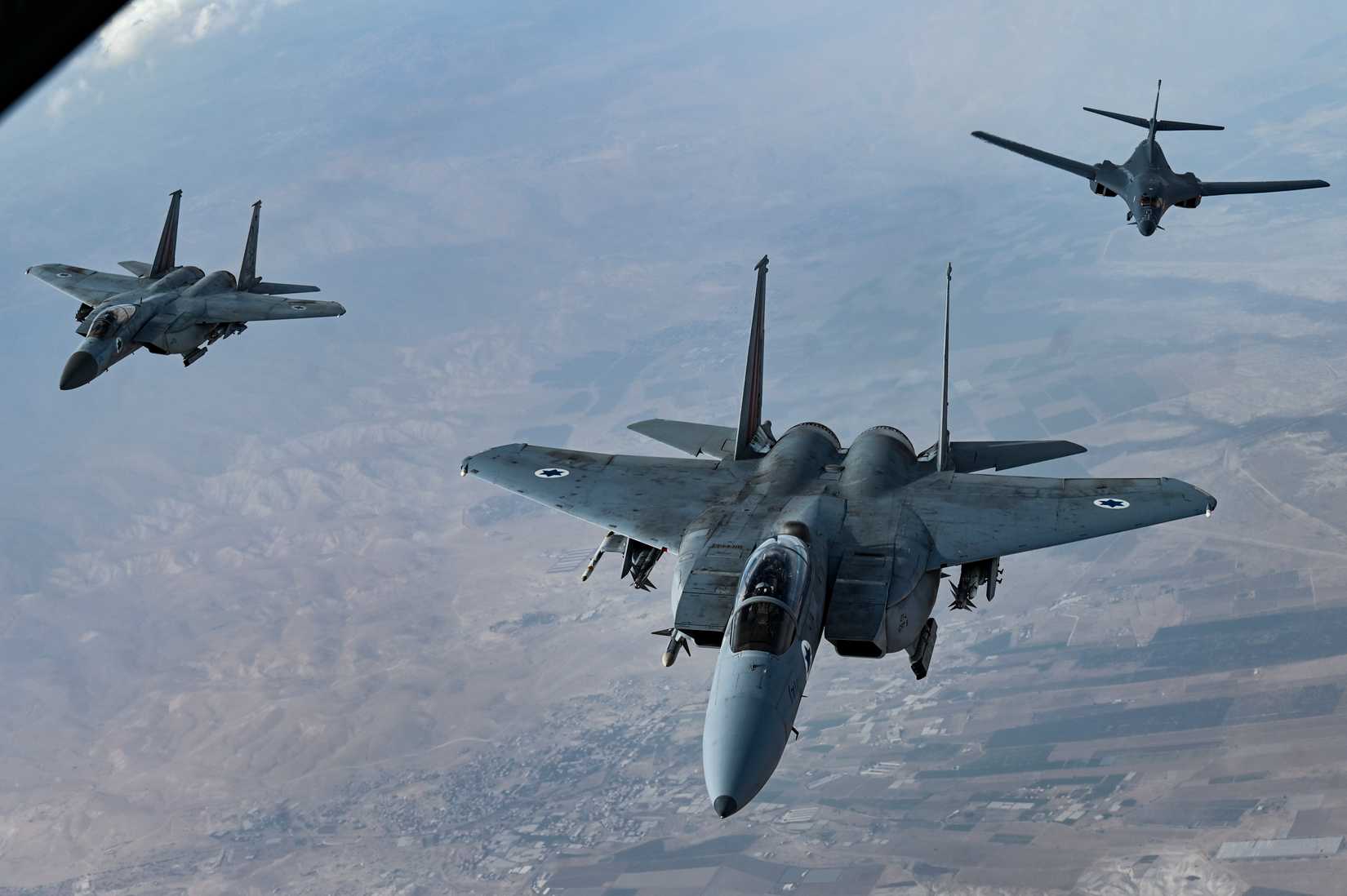 Israeli Air Force F-15 Strike Eagles accompany a U.S. Air Force B-1B Lancer over Israel as part of a presence patrol.