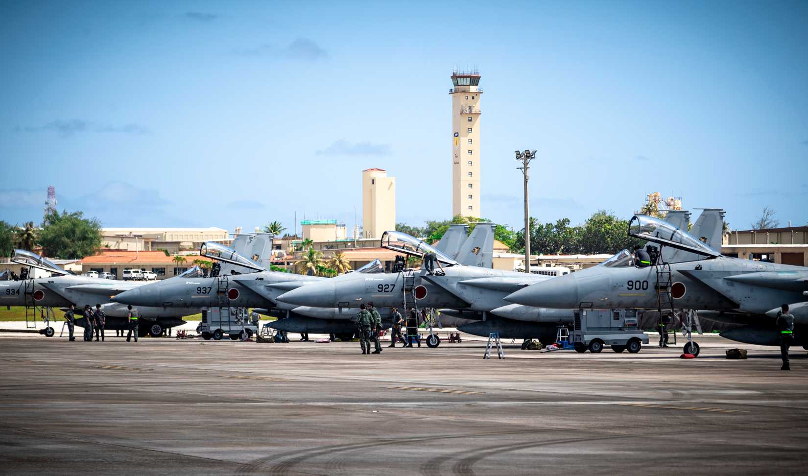 Japan Air Self-Defense Force, or Koku-Jieitai, members rally around Koku-Jieitai F-15J Eagles after landing at Andersen Air Force Base, Guam.