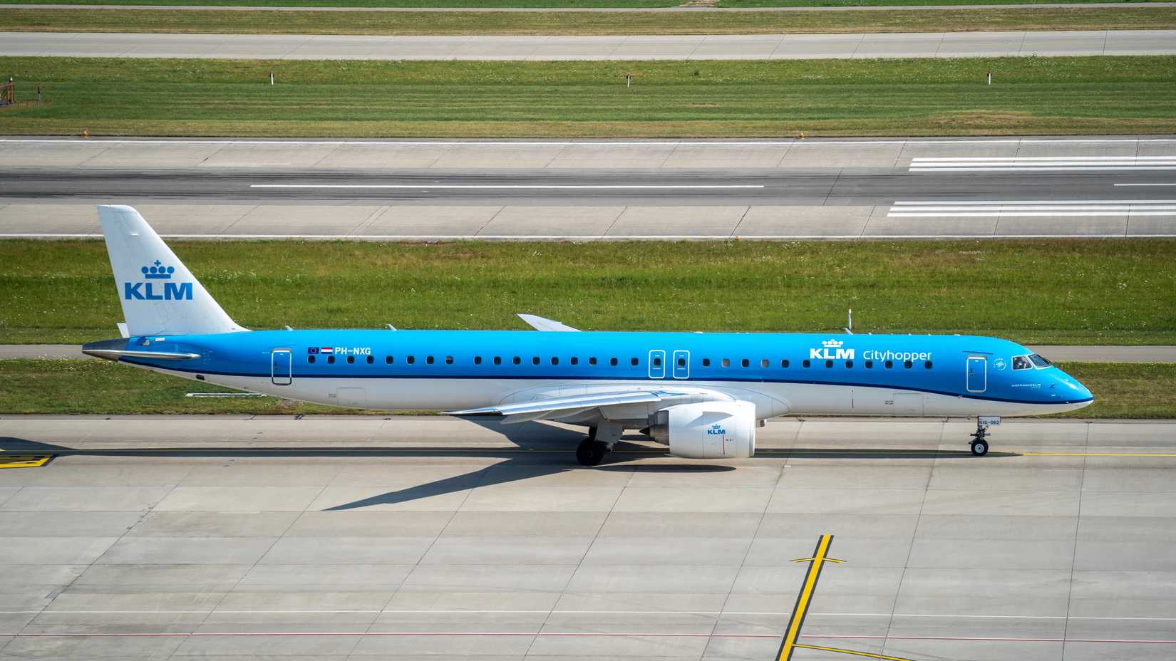 . KLM Embraer 195 is taxiing at ZRH international airport.