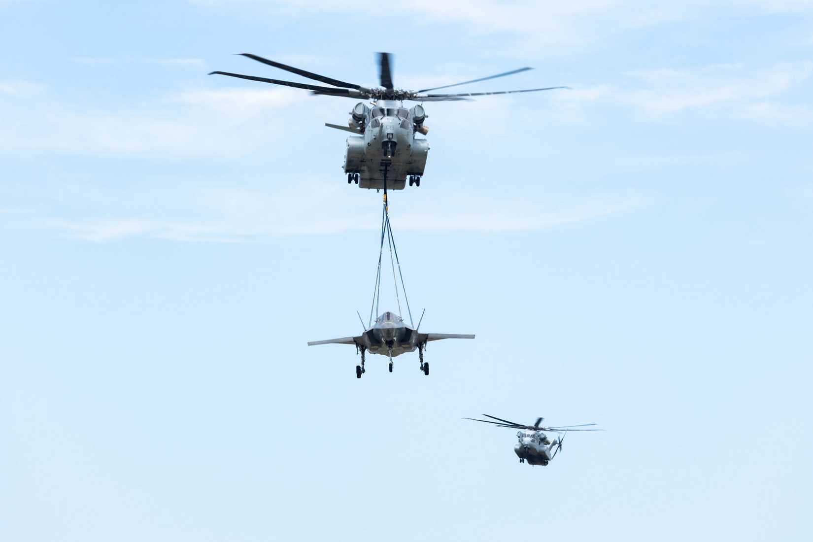 Marine Corps heavy-lift Sikorsky CH-53K King Stallion helicopter conducts a F-35B Lighting II long-range external lift