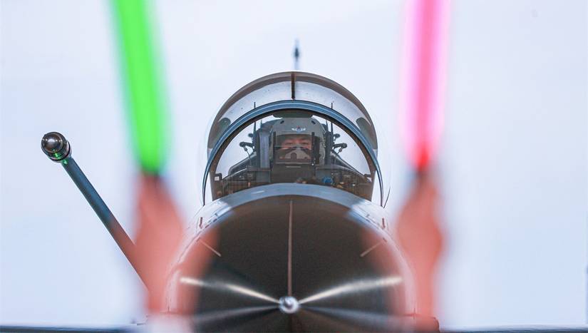 Pilot assigned to an aviation brigade with the air force under the Chinese PLA Southern Theater Command returns to the parking apron after completing a nighttime flight training exercise in mid-June, 2025.