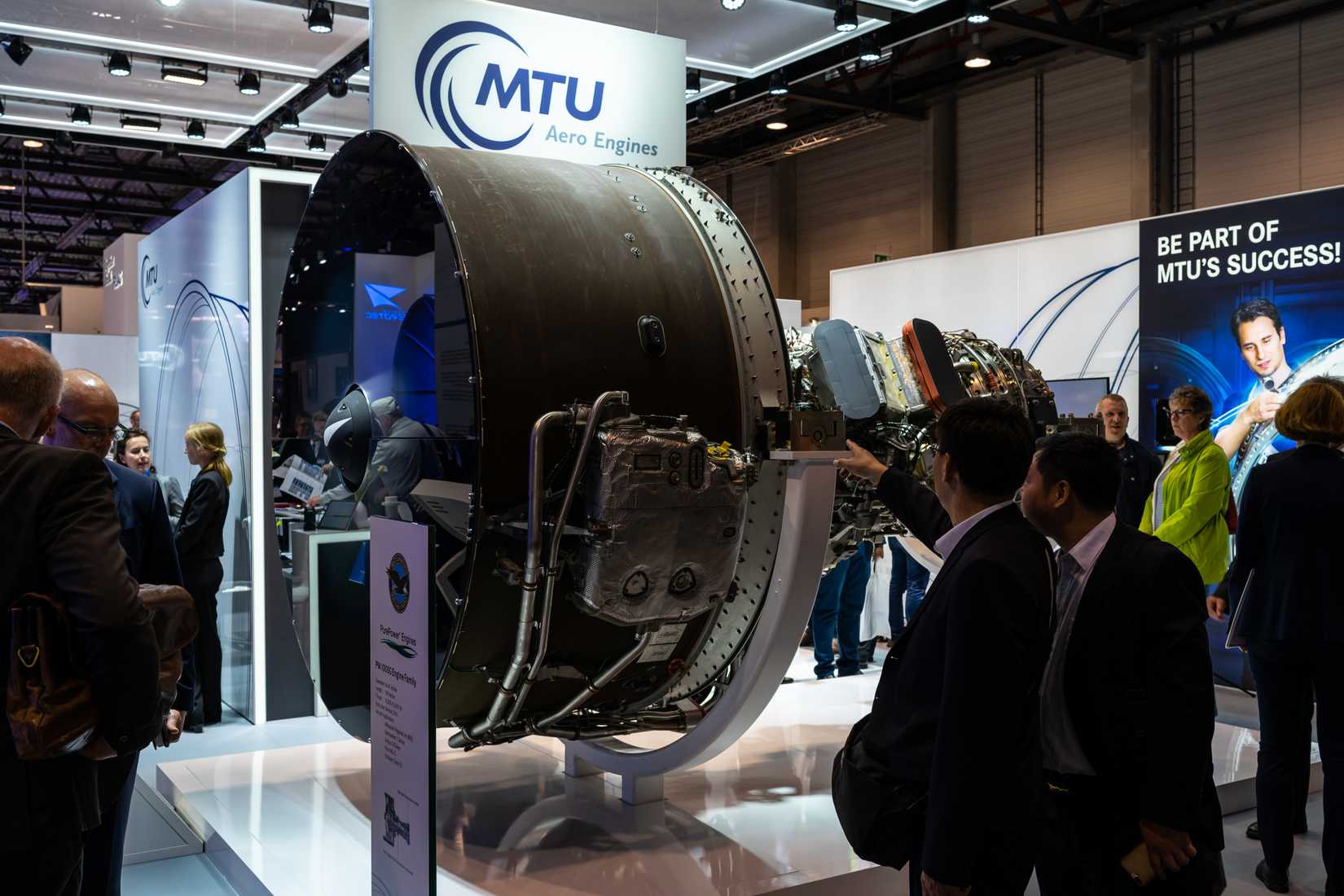 The stand of MTU Aero Engines and high-bypass geared turbofan engine family Pratt & Whitney PW1000G. Exhibition ILA Berlin Air Show 2018