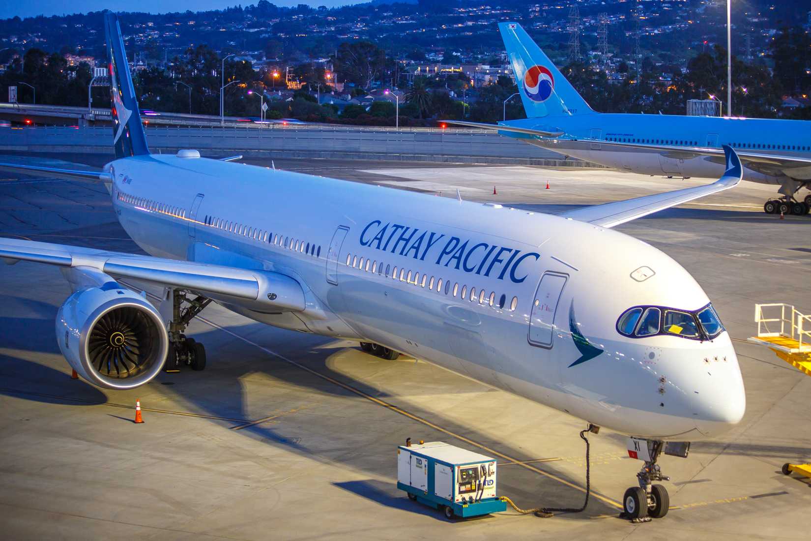 A Cathay Pacific A350-900 parked on the tarmac awaiting to be towed to the gate for a flight to Hong Kong
