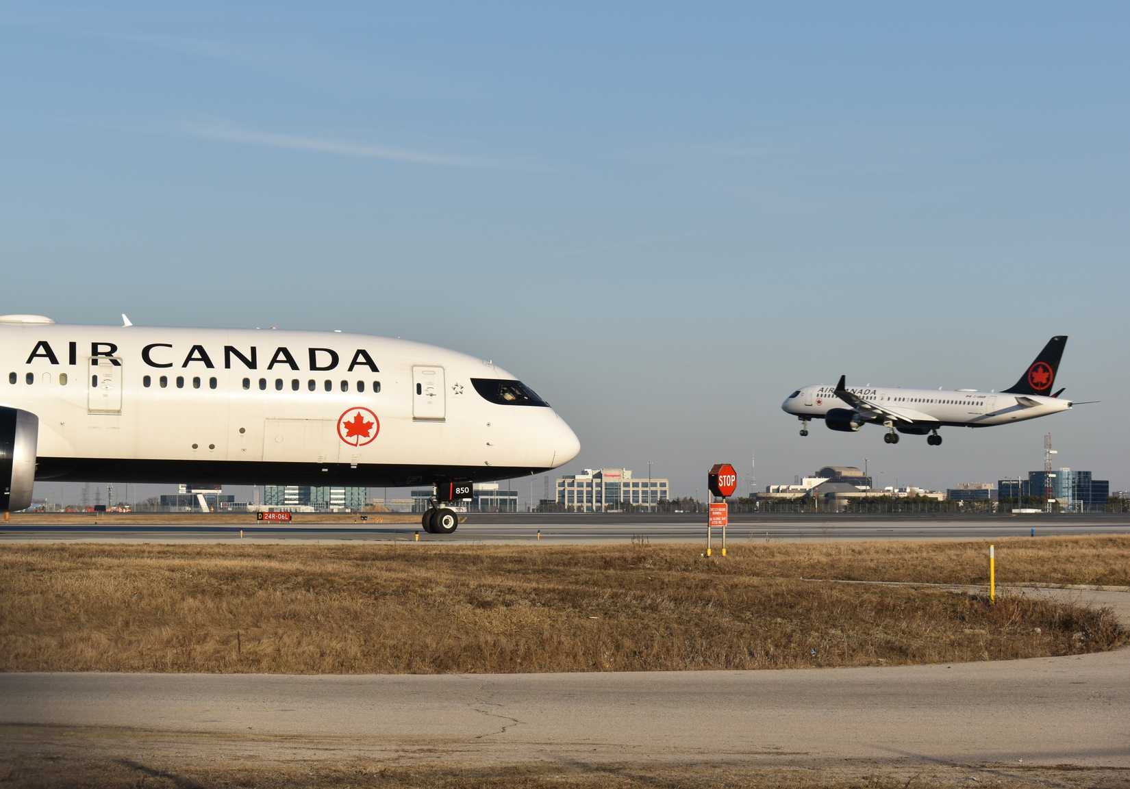 Air Canada one aircraft on the runway and other aircraft landing