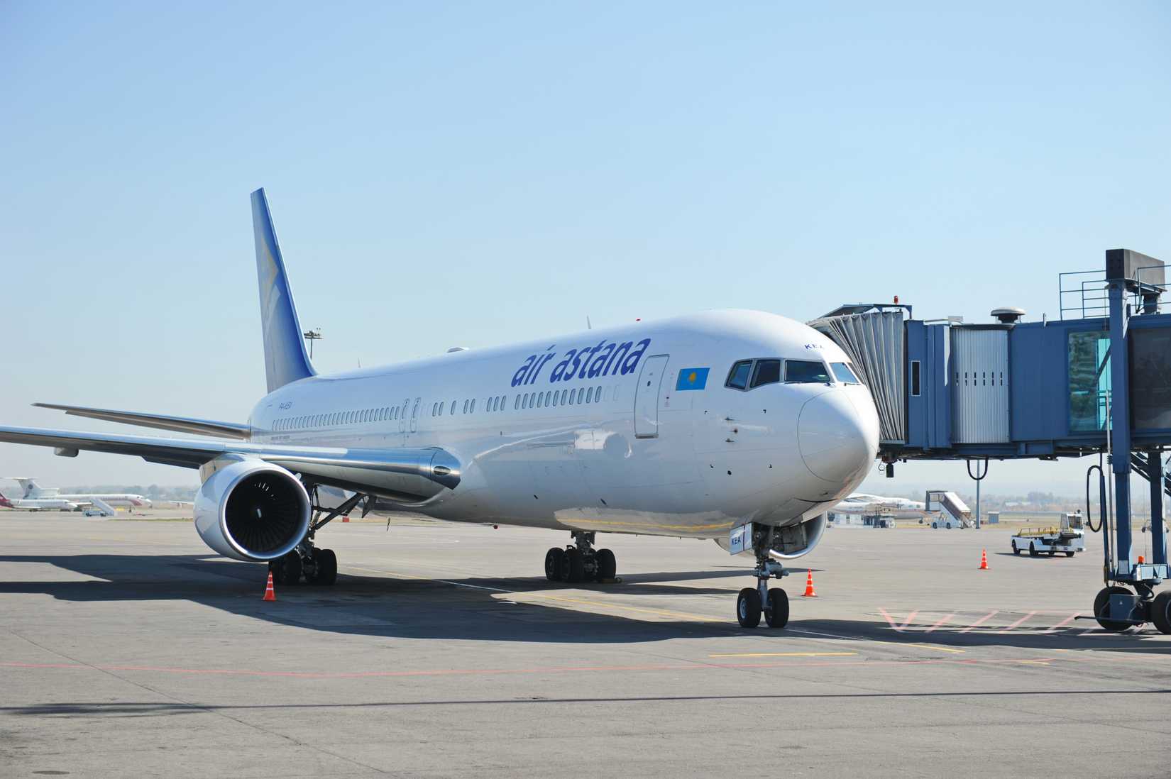 An Air Astana aircraft parked at a gate area