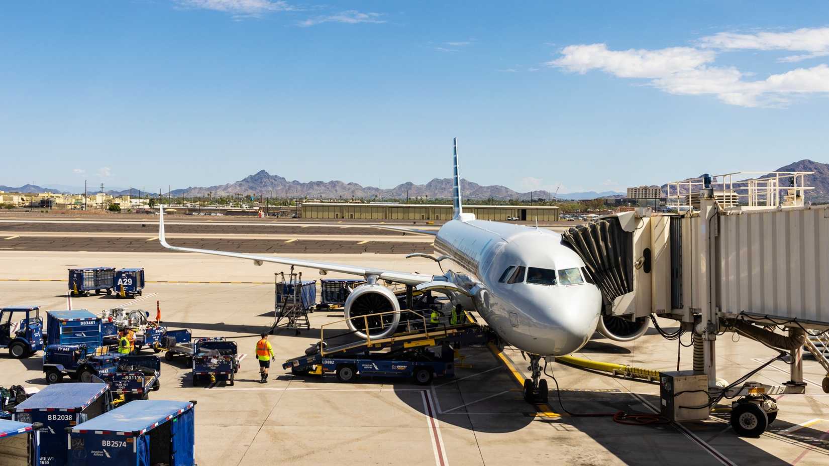 A white aircraft parked at a gate area