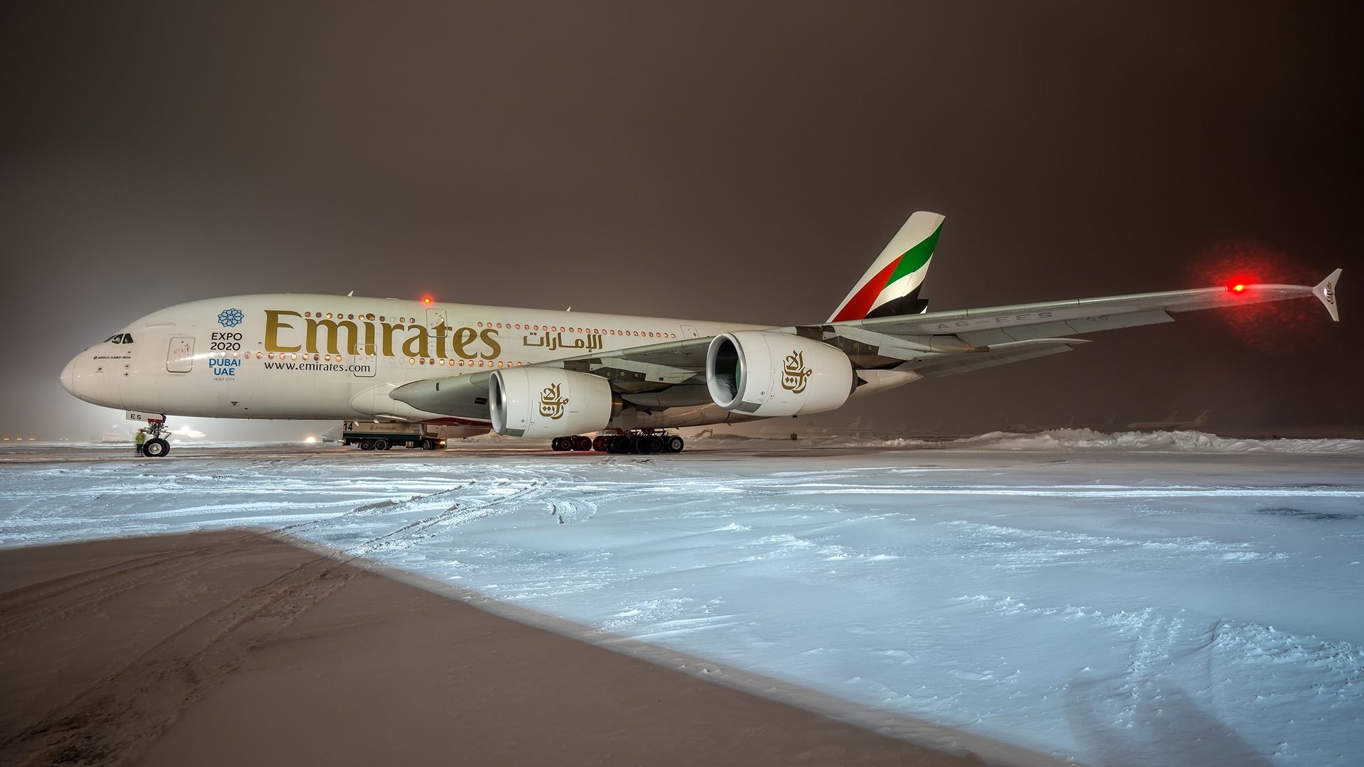 An Emirates Airbus A380 superjumbo parked at an airport 