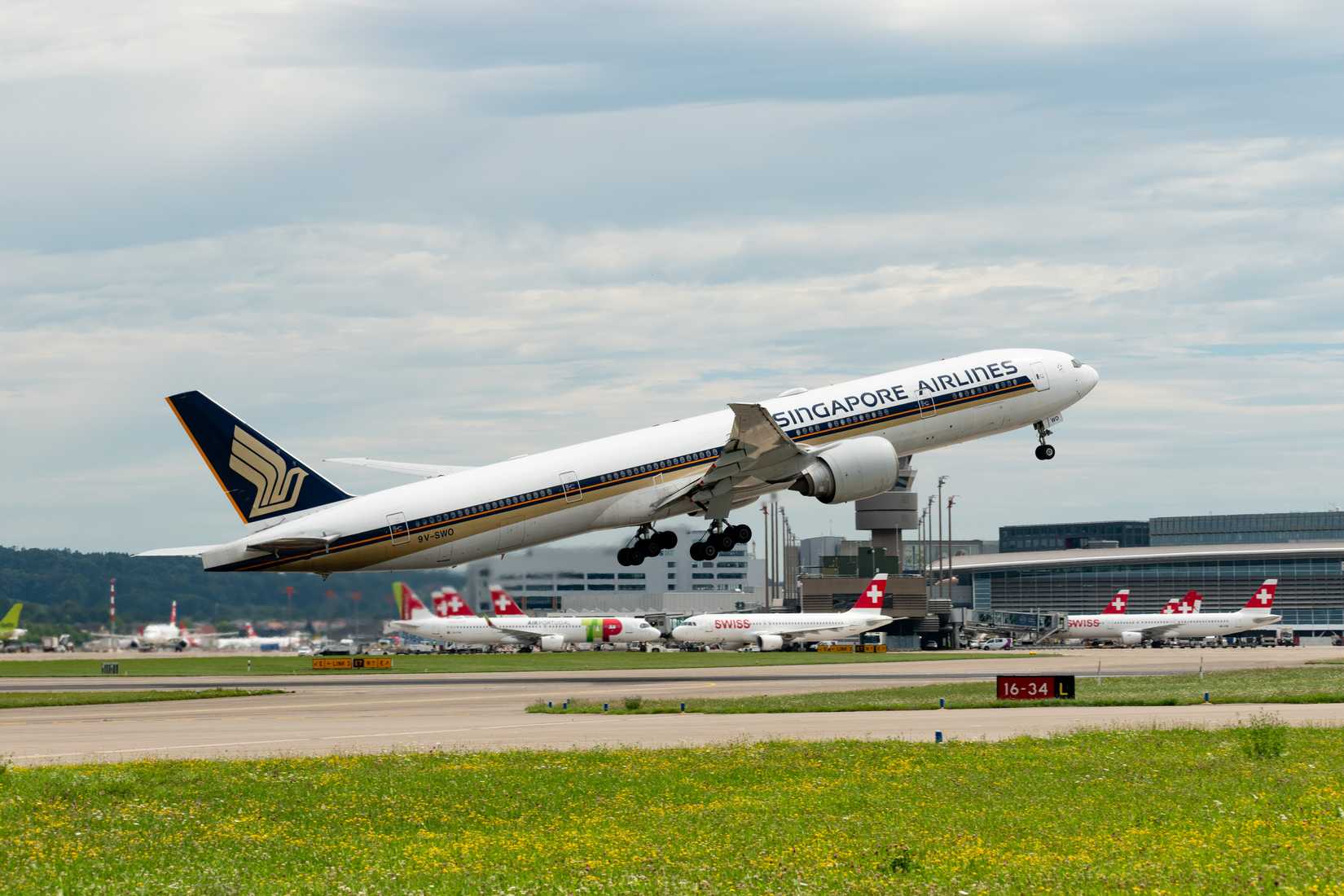Singapore Airlines Boeing 777-312ER aircraft is taking off from runway 16.