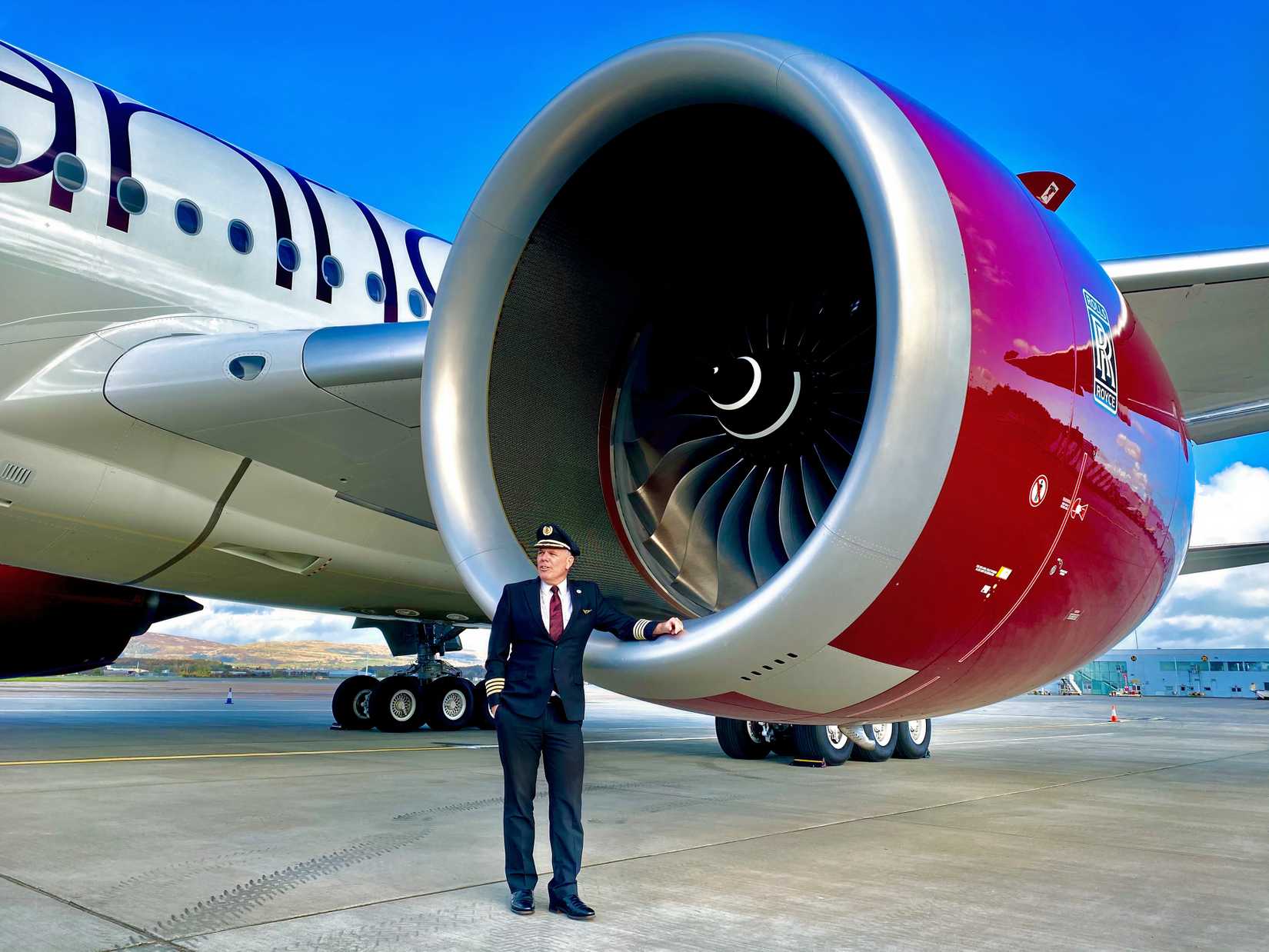 Captain Chris Standing In Front Of An Engine