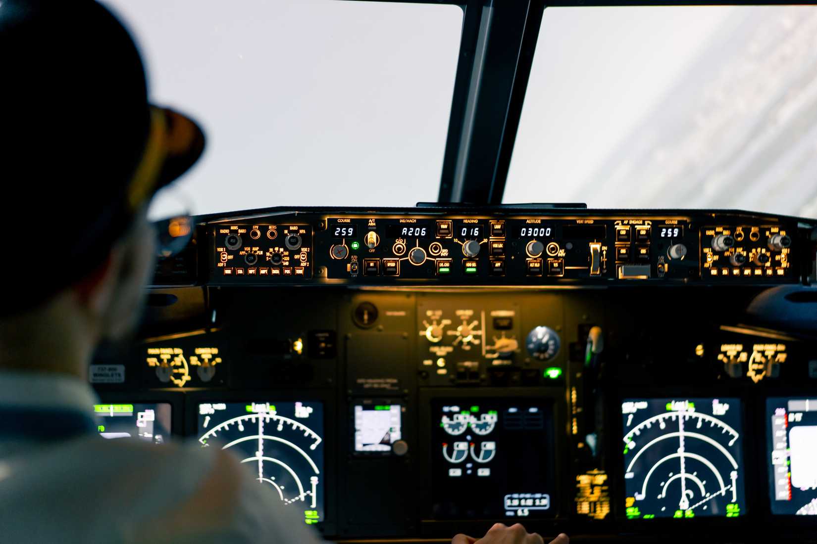 The pilot in the cockpit controls the plane during flight turbulence flight simulator transportation.