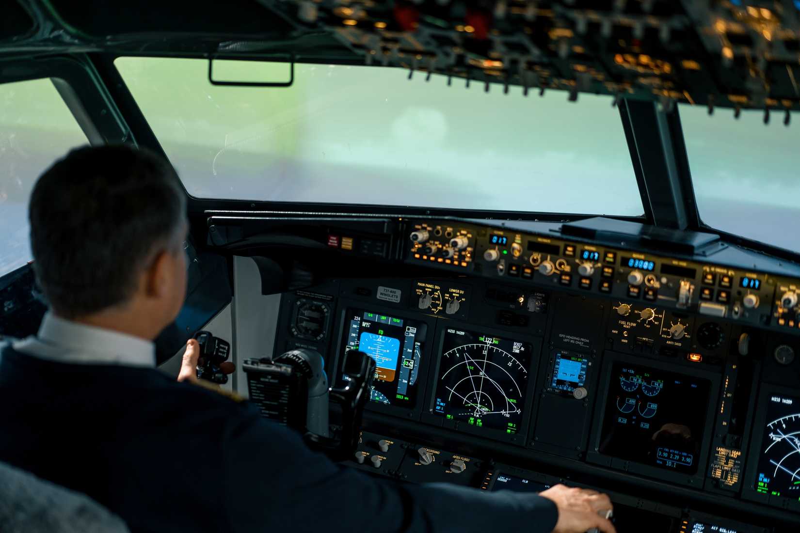 The pilot in the cockpit of the aircraft turbulence during flight Flight simulator navigation devices.